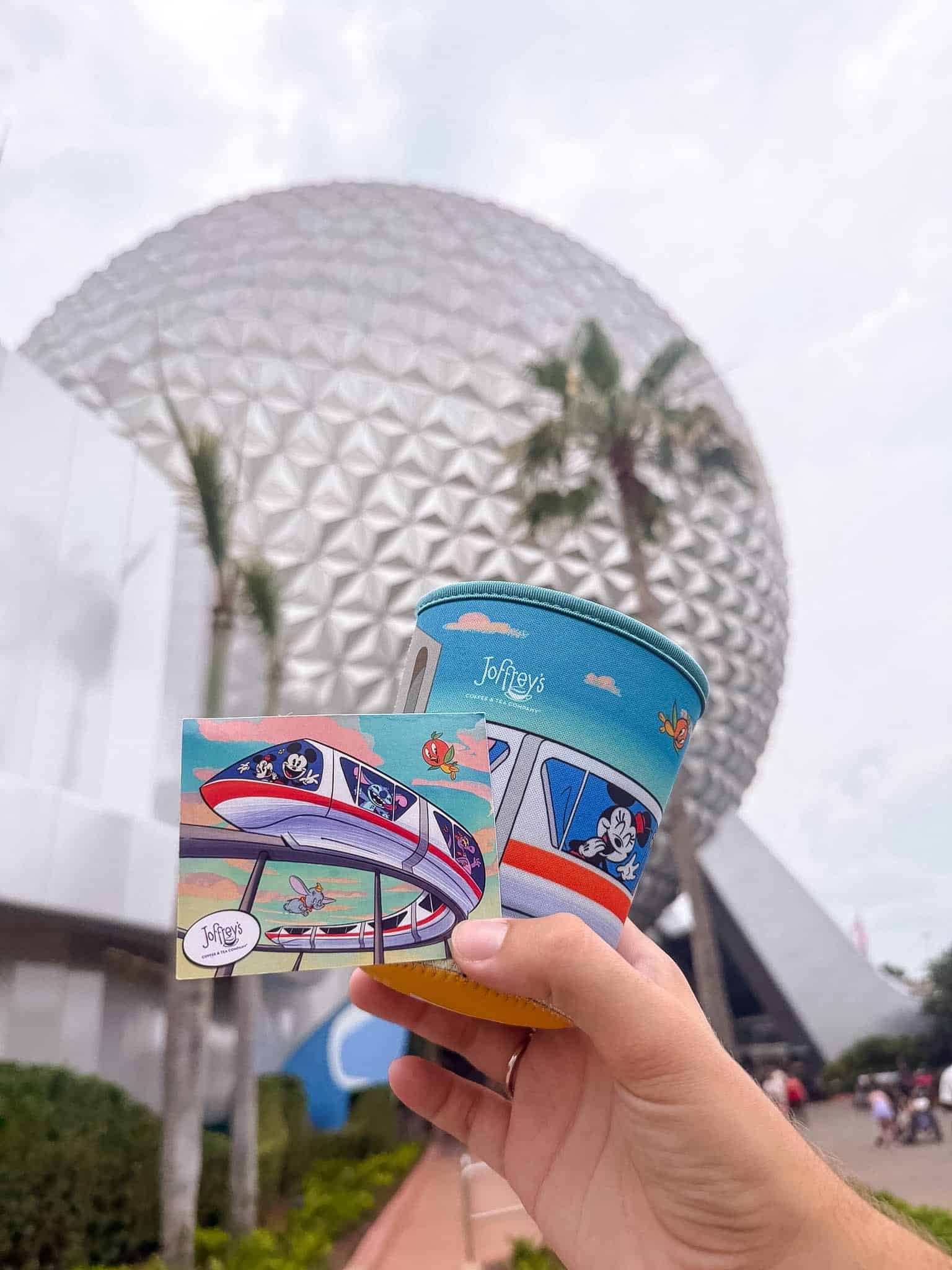 a hand holding the Joffrey's challenge prize which is a passholder themed Coozie 