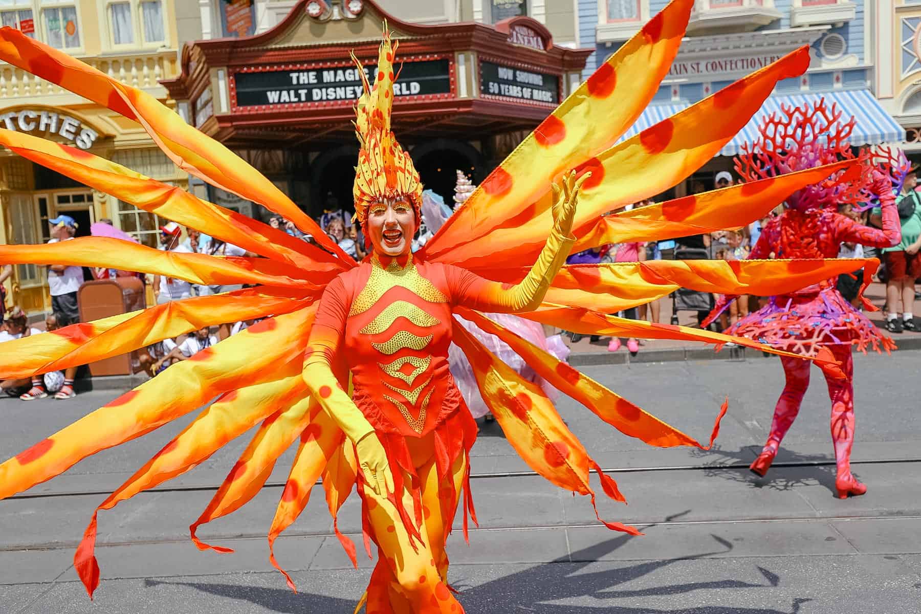 Performers dressed in vibrant colors as part of The Little Mermaid unit. 