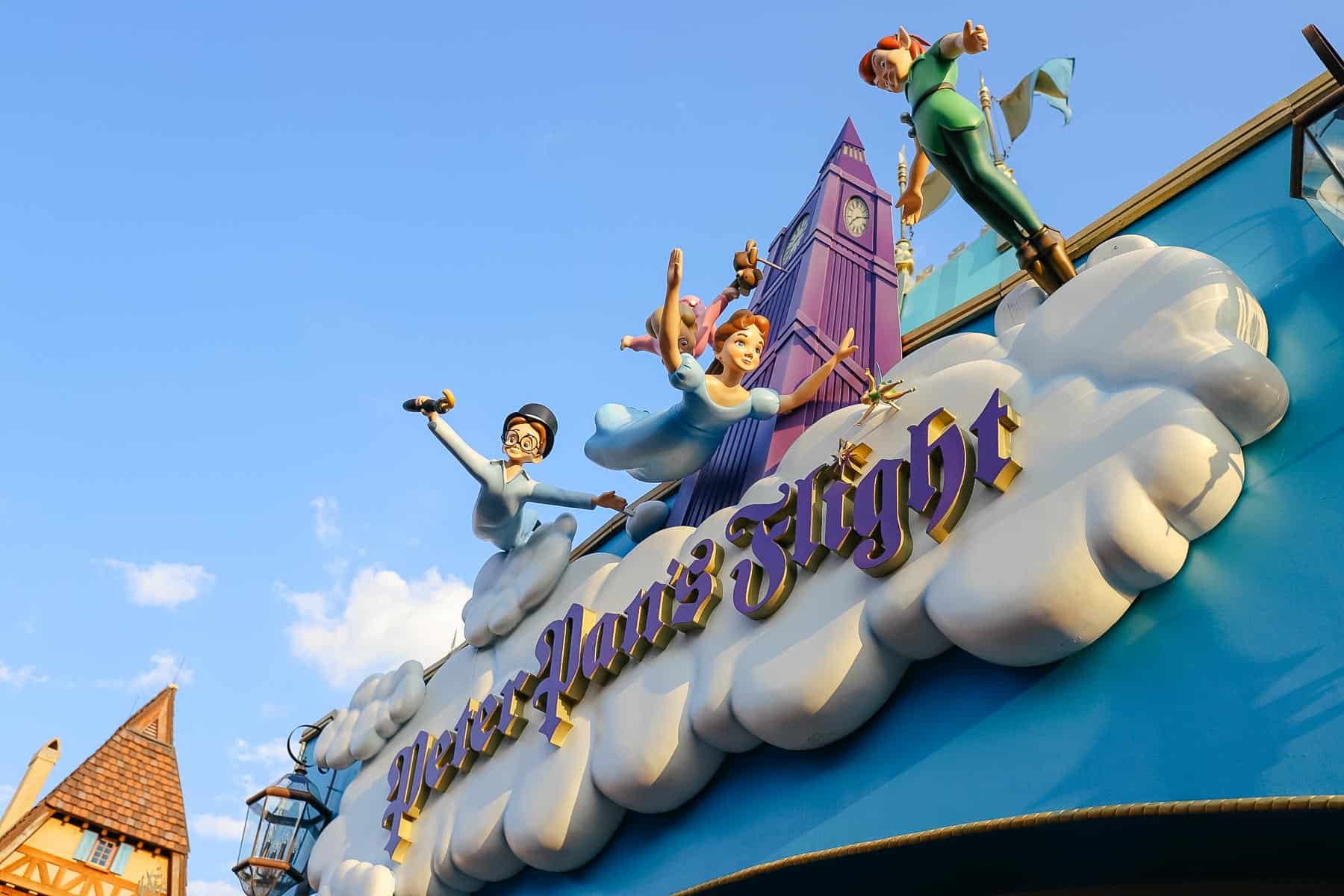 Peter Pan, Wendy, Jon, and Michael flying above Neverland. 