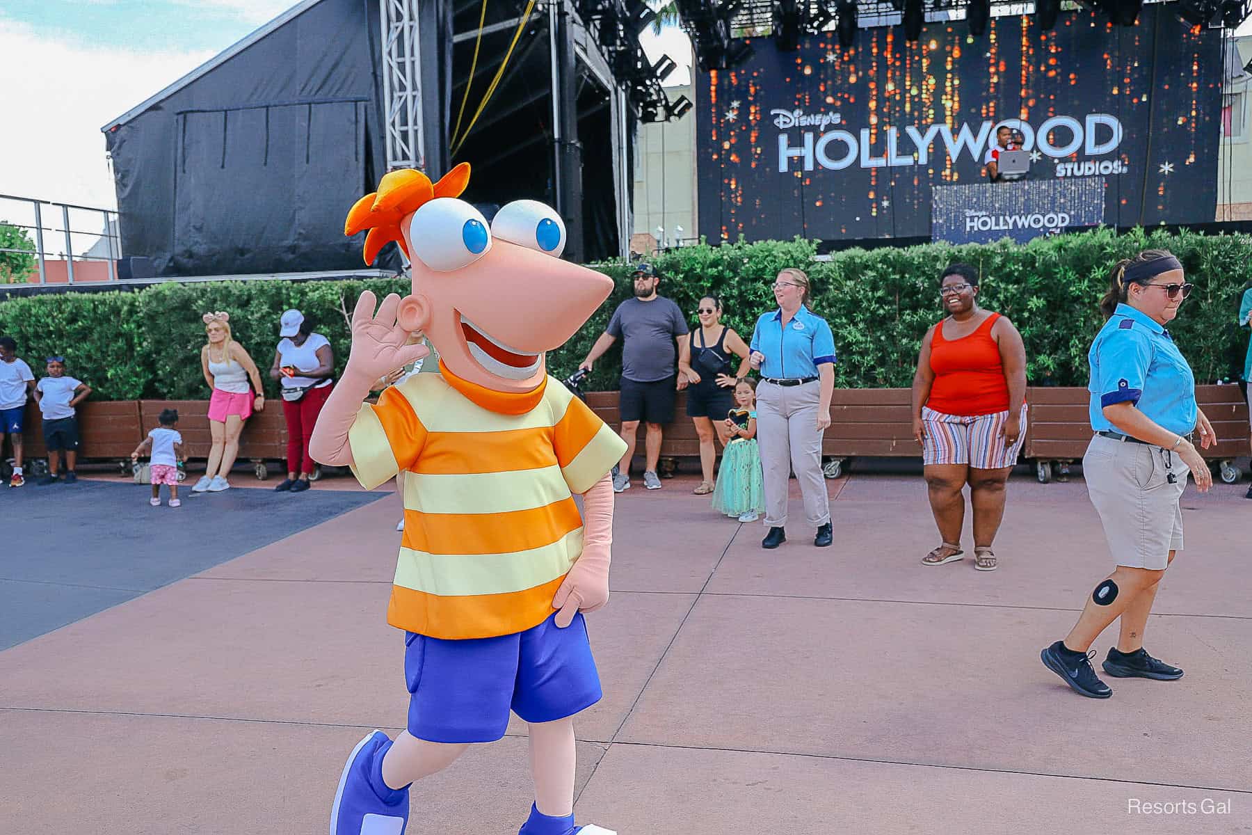 Phineas waves from the dance floor at a pop up dance party.