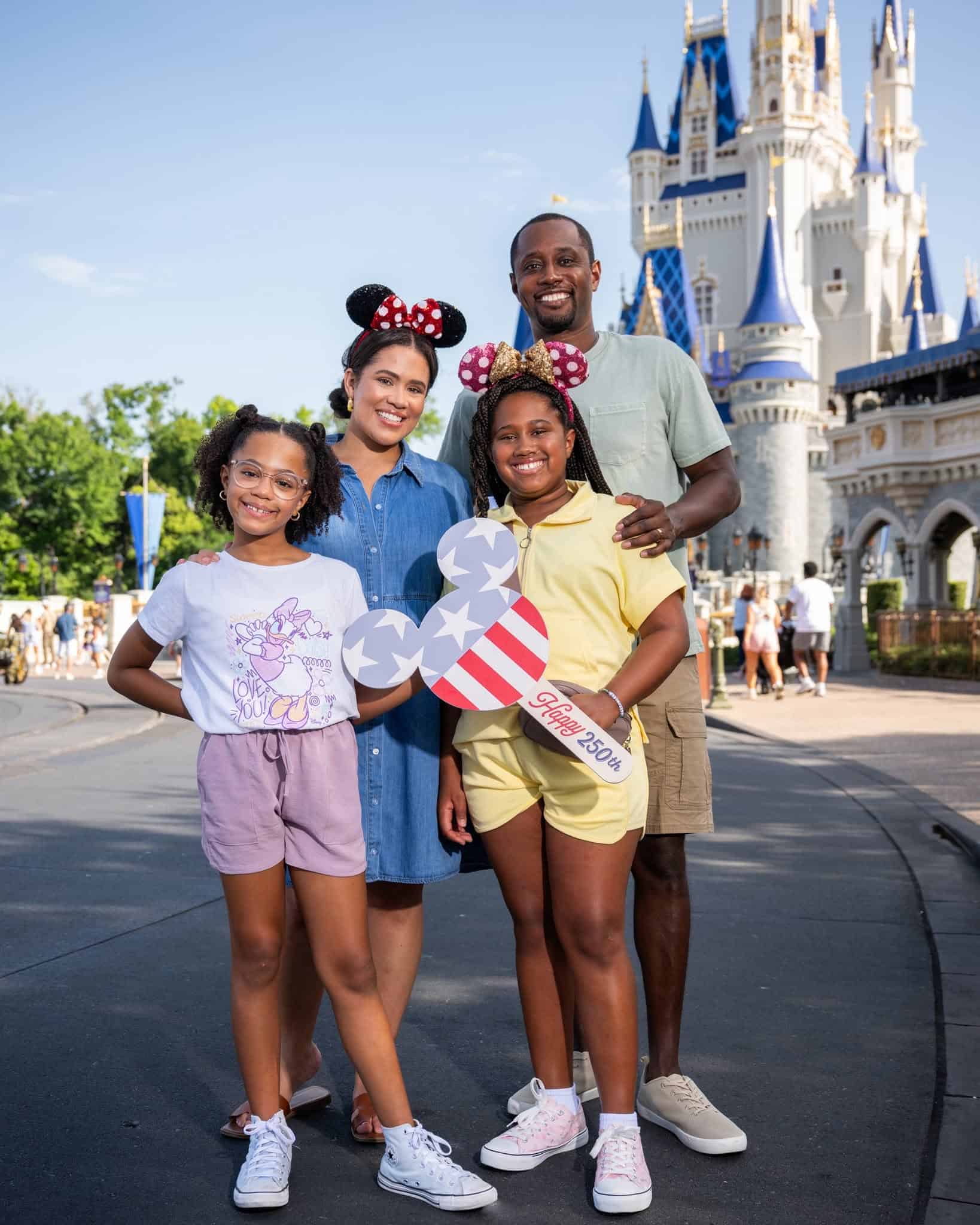 a family having a photo made with a 4th of July Mickey shaped prop