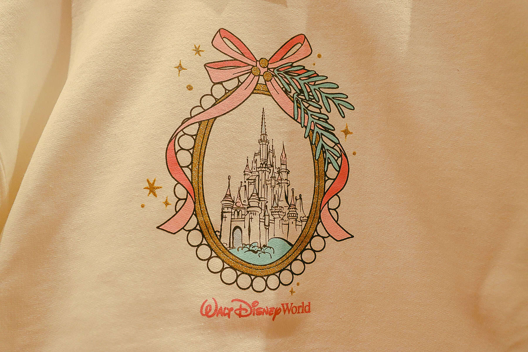 a close up of the pink castle bow cameo with the Walt Disney World logo