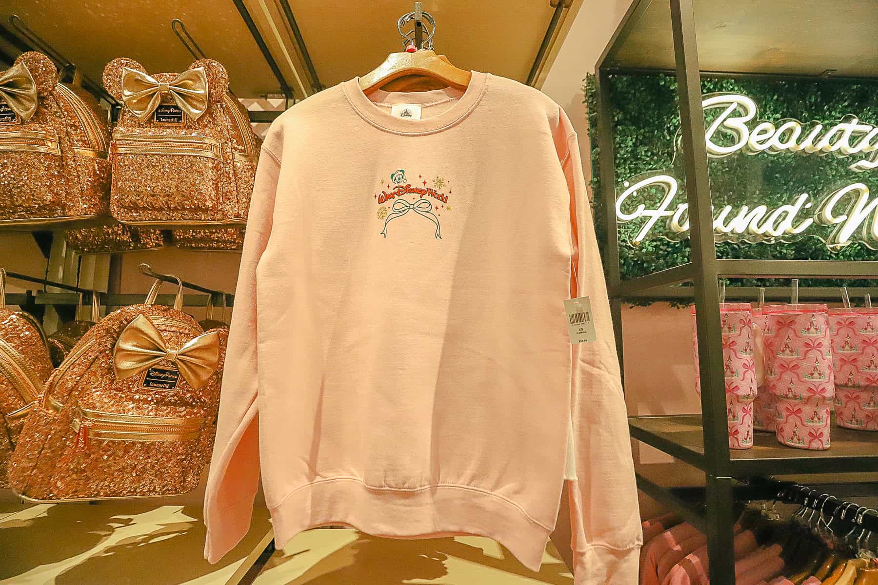 a soft pink sweatshirt with a bow