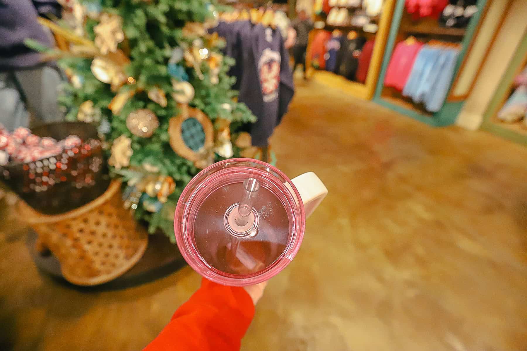 the top of the tumbler has a pink see-through lid