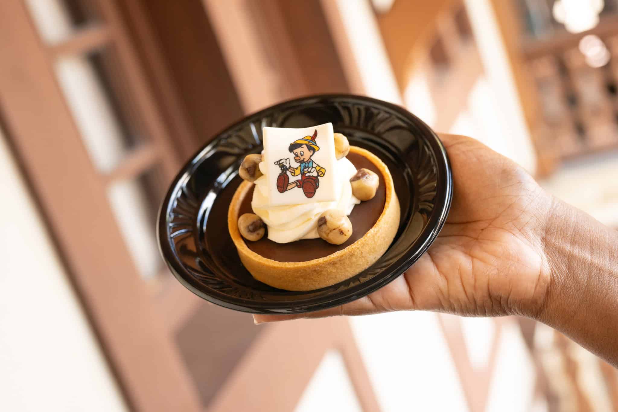 Pinocchio topped white candy on a tart
