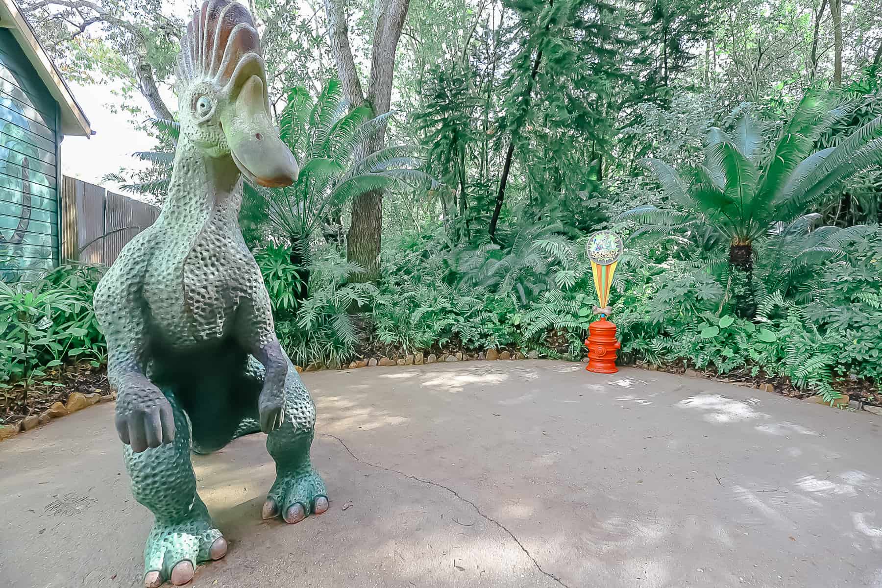 a dinosaur sits beside the meet-and-greet location 