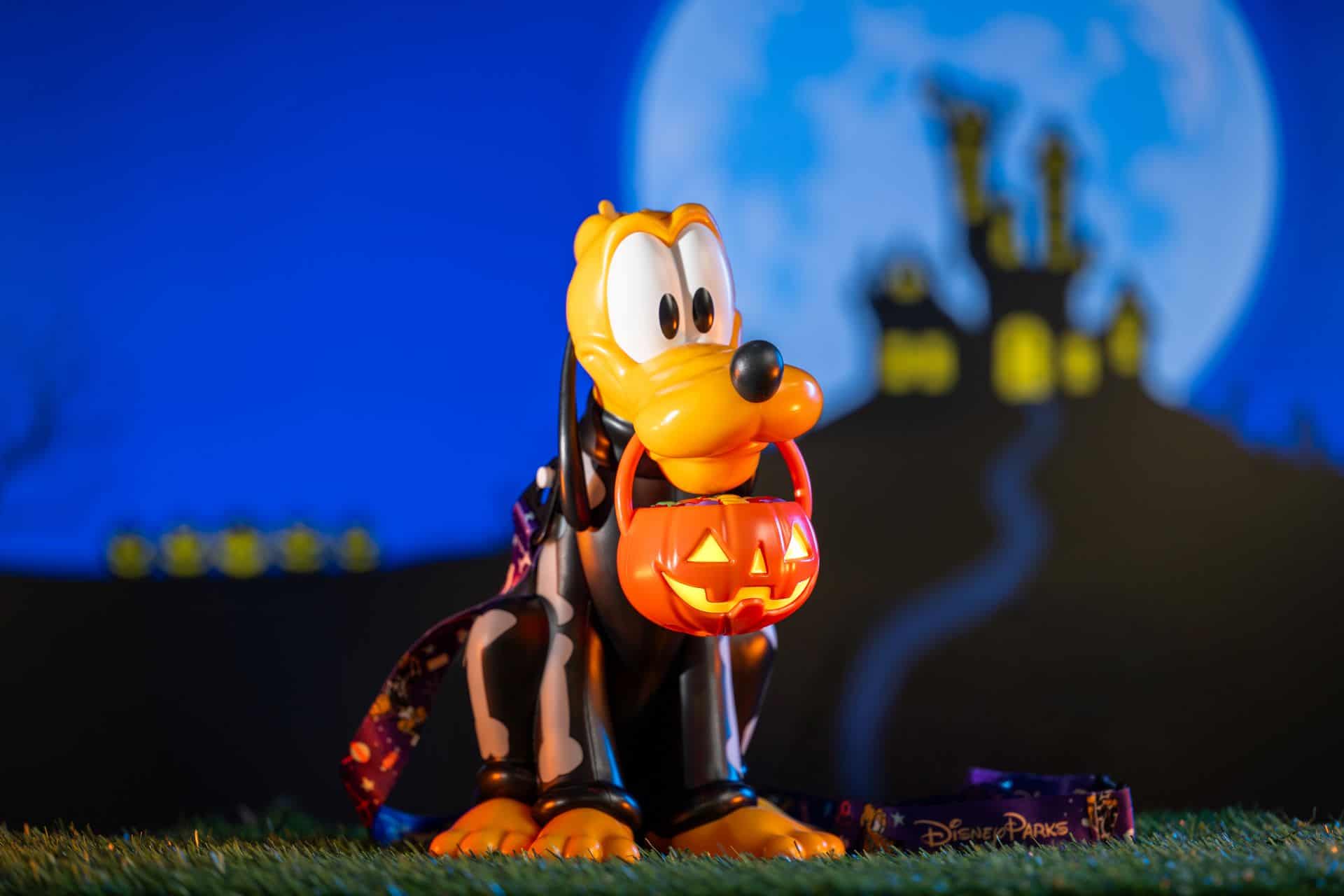 a plastic Pluto sipper cup with a skeleton costume