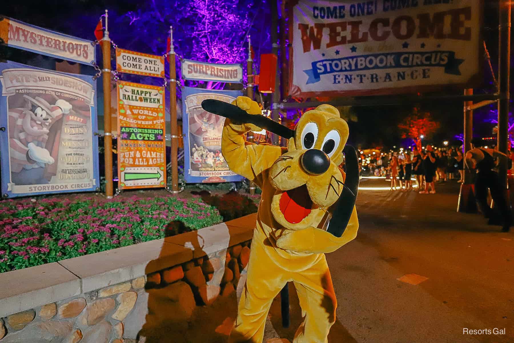 Pluto poses for a photo at Mickey's Halloween Party in front of Storybook Circus