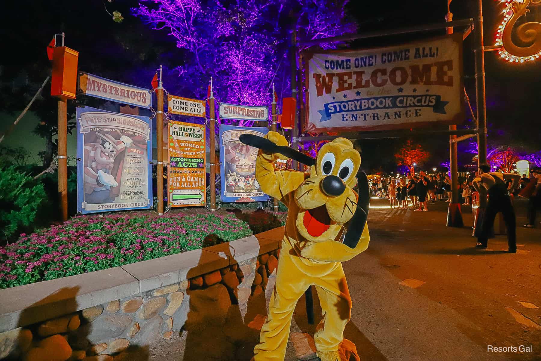 Pluto in front o f the Storybook Circus entrance signage