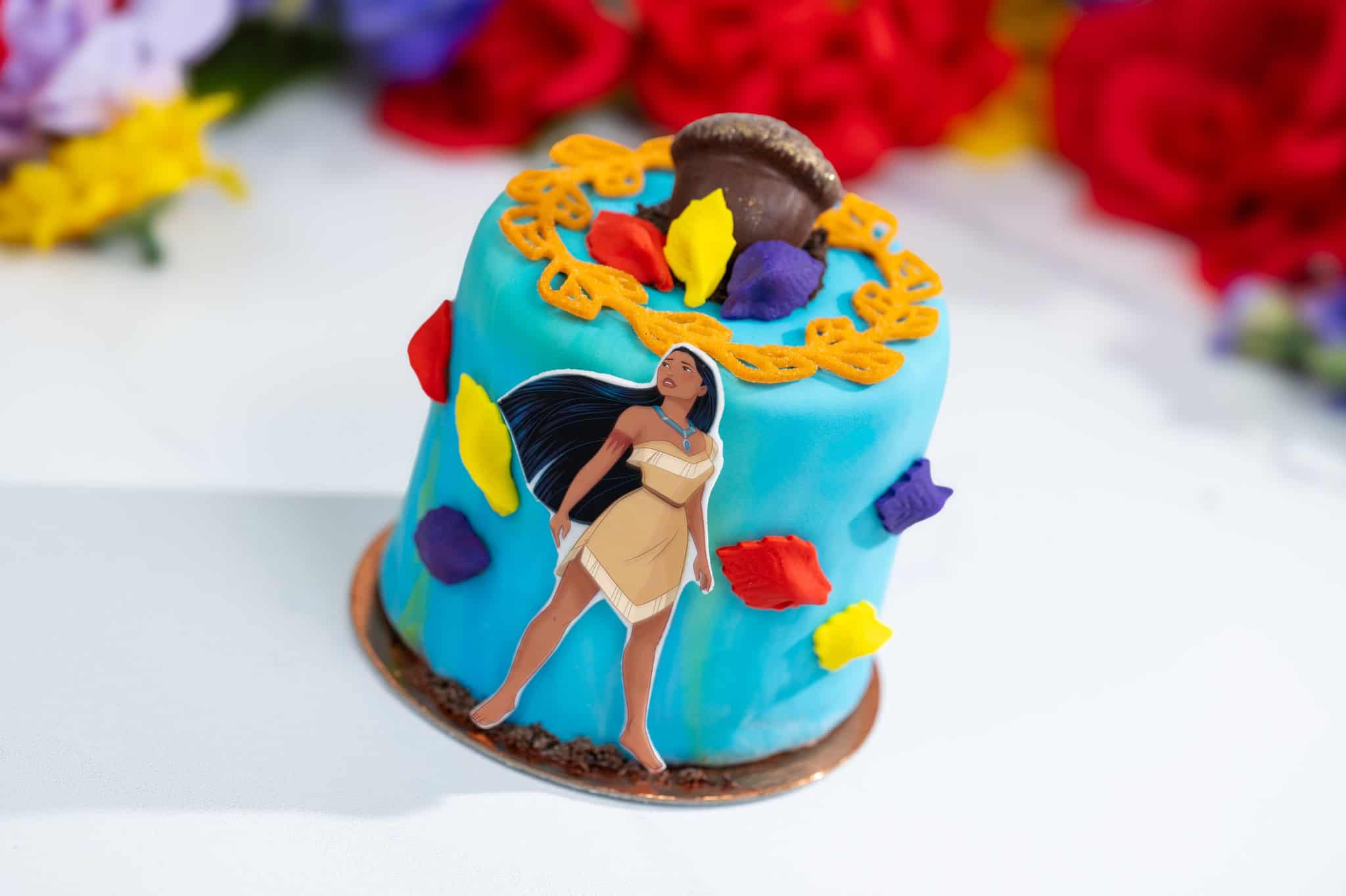 a blue petit cake with leaf decor and a Pocahontas cutout 
