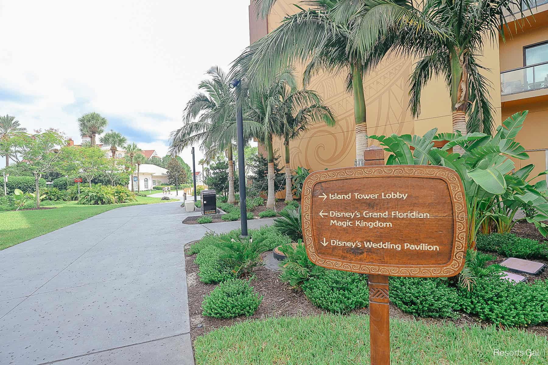a sign that shows both the Polynesian and Grand Floridian in the background