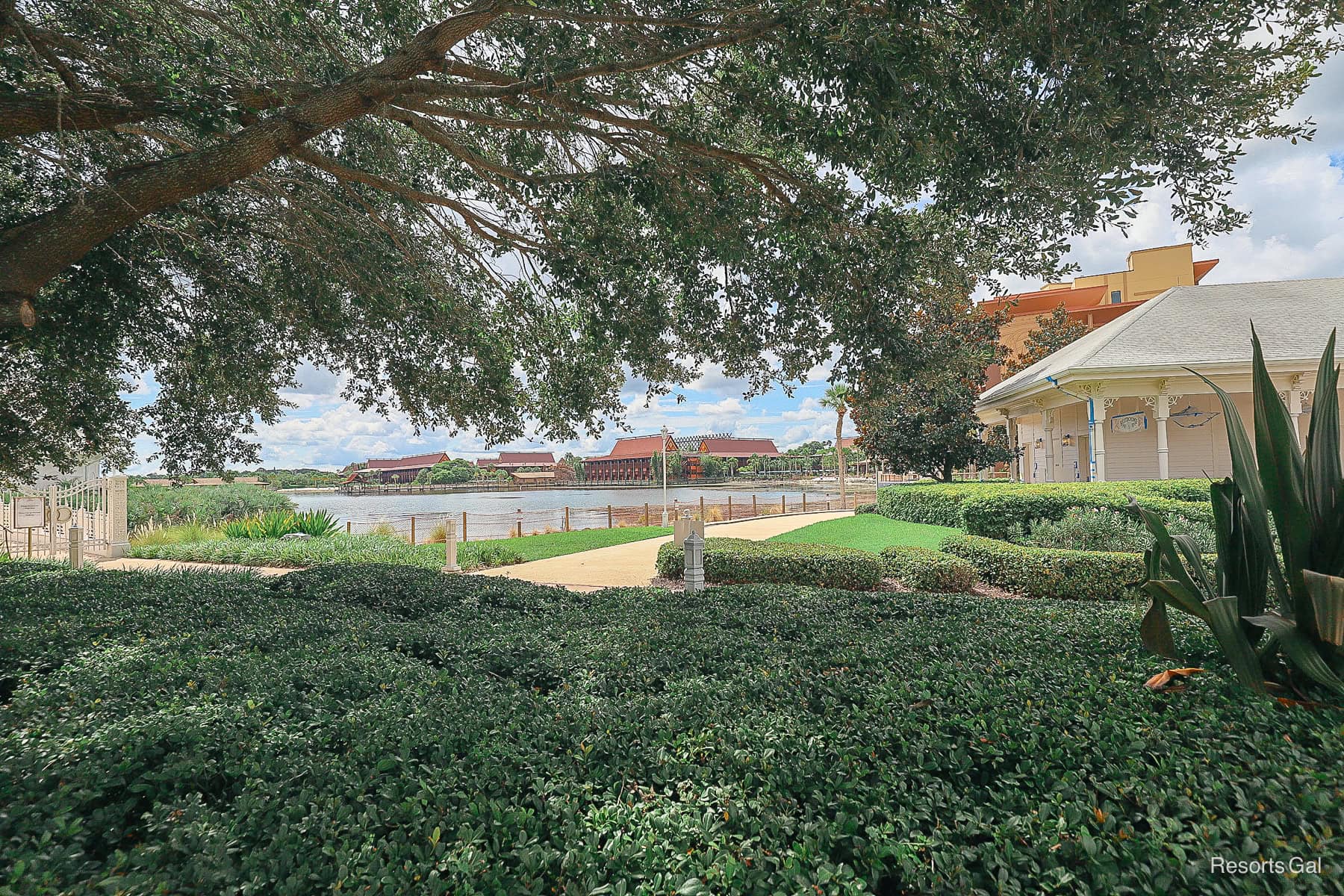 a view of the Polynesian's shoreline from the walking path near the Grand Floridian wedding chapel
