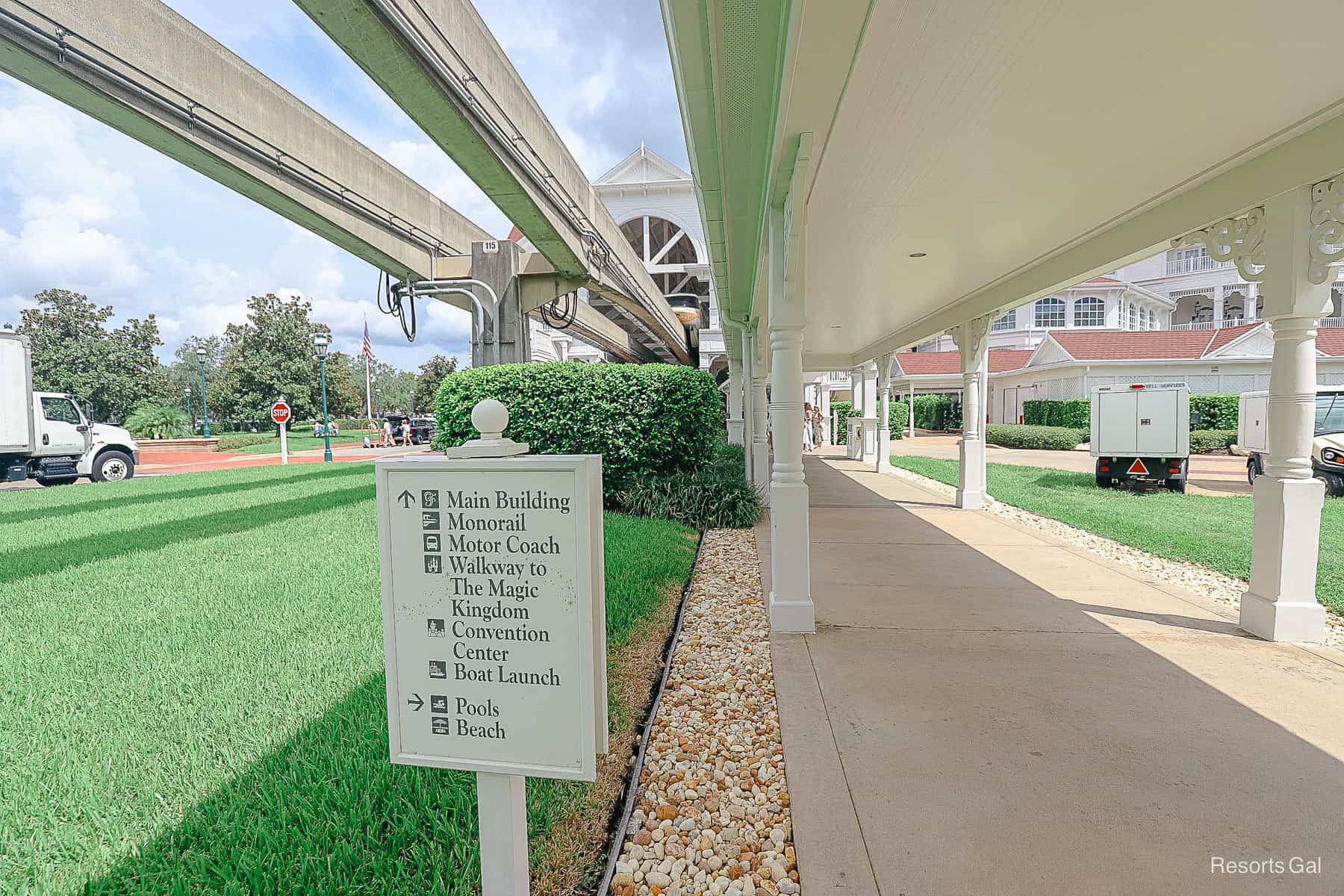 a sign with directionals pointing to the main building and the monorail