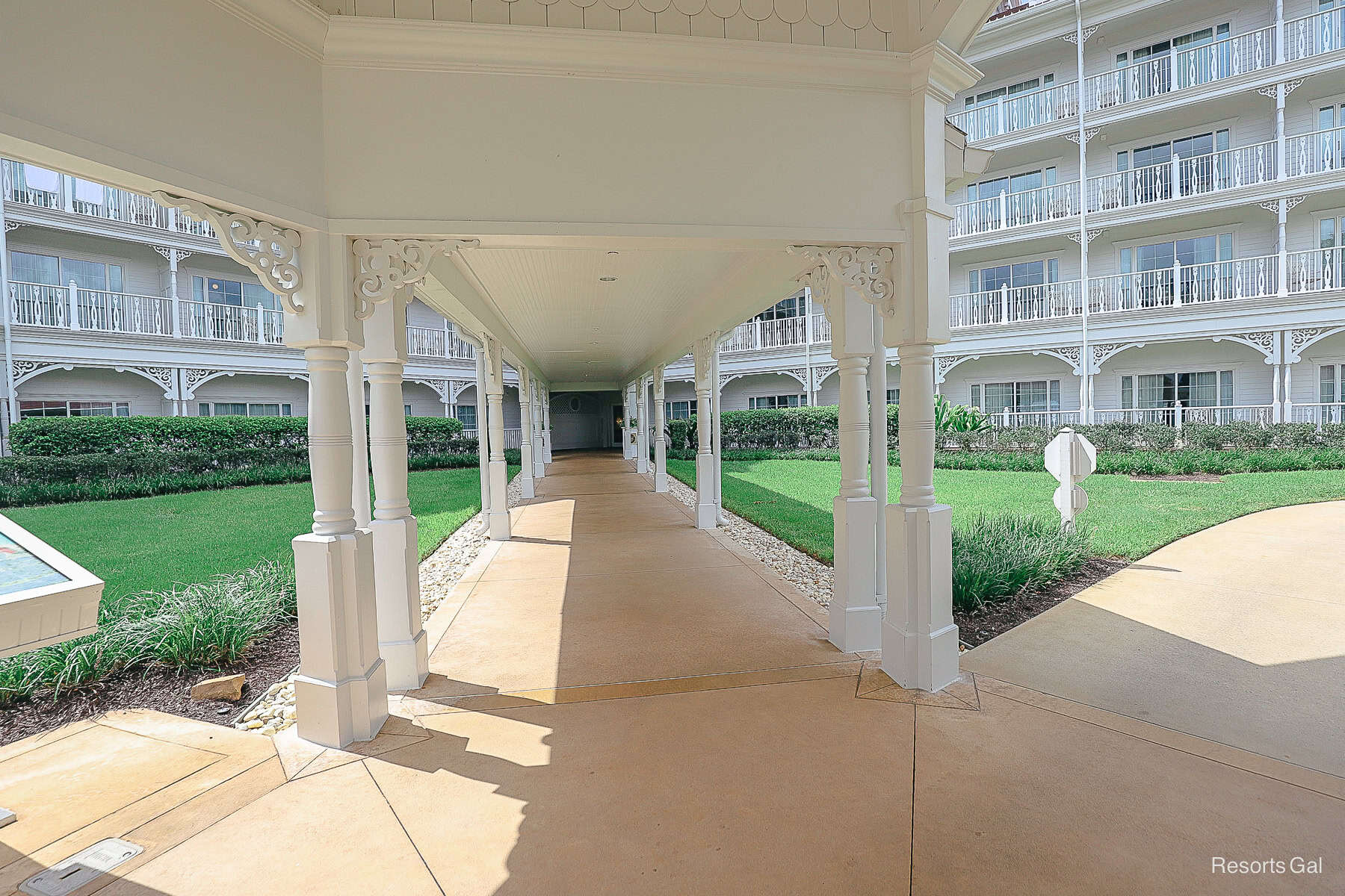 a fountain next to the covered walkway