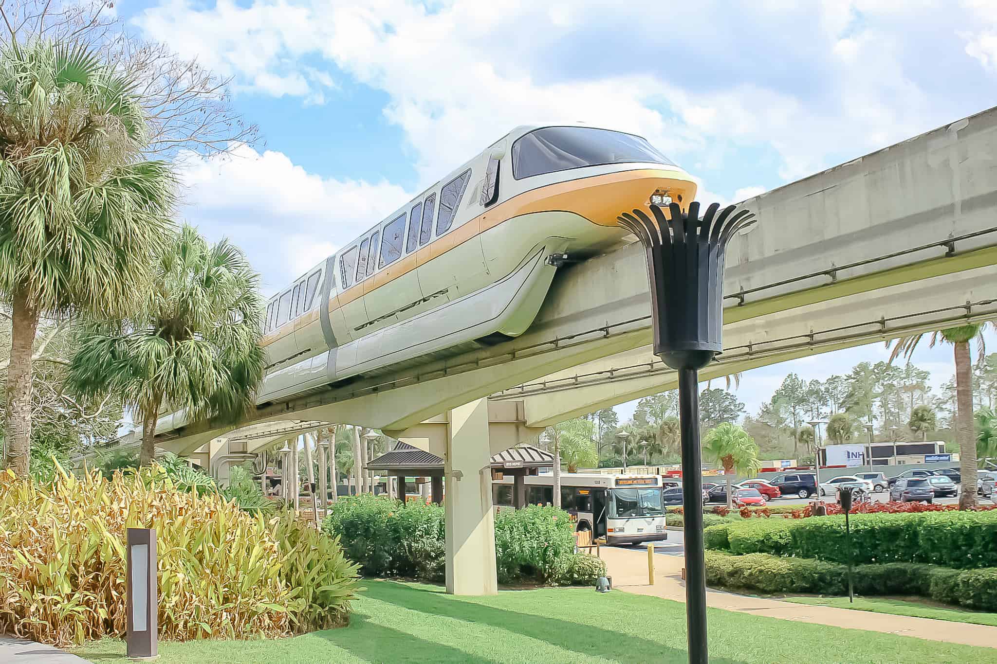 Monorail peach passes a tiki torch at Disney's Polynesian Village Resort 