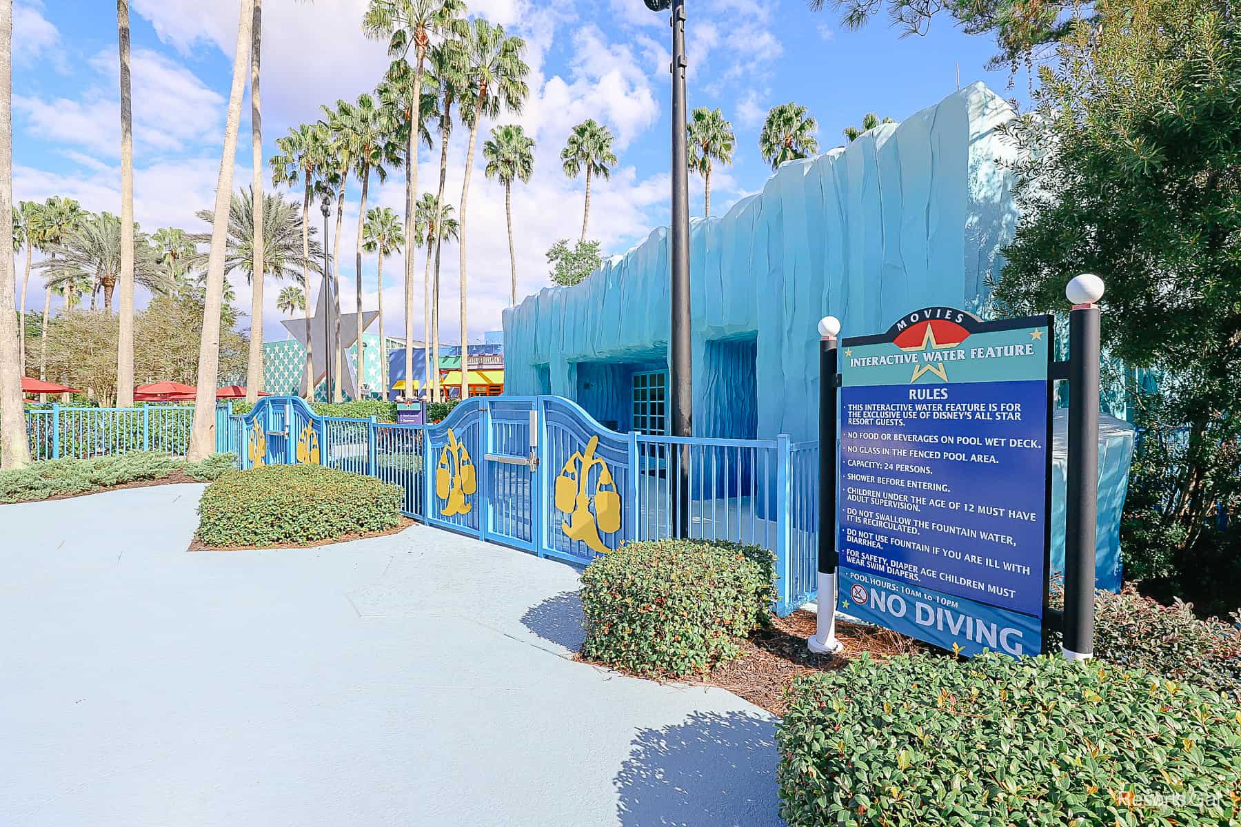 The gate to the Fantasia Pool at All-Star Movies with the rules and hours posted. 