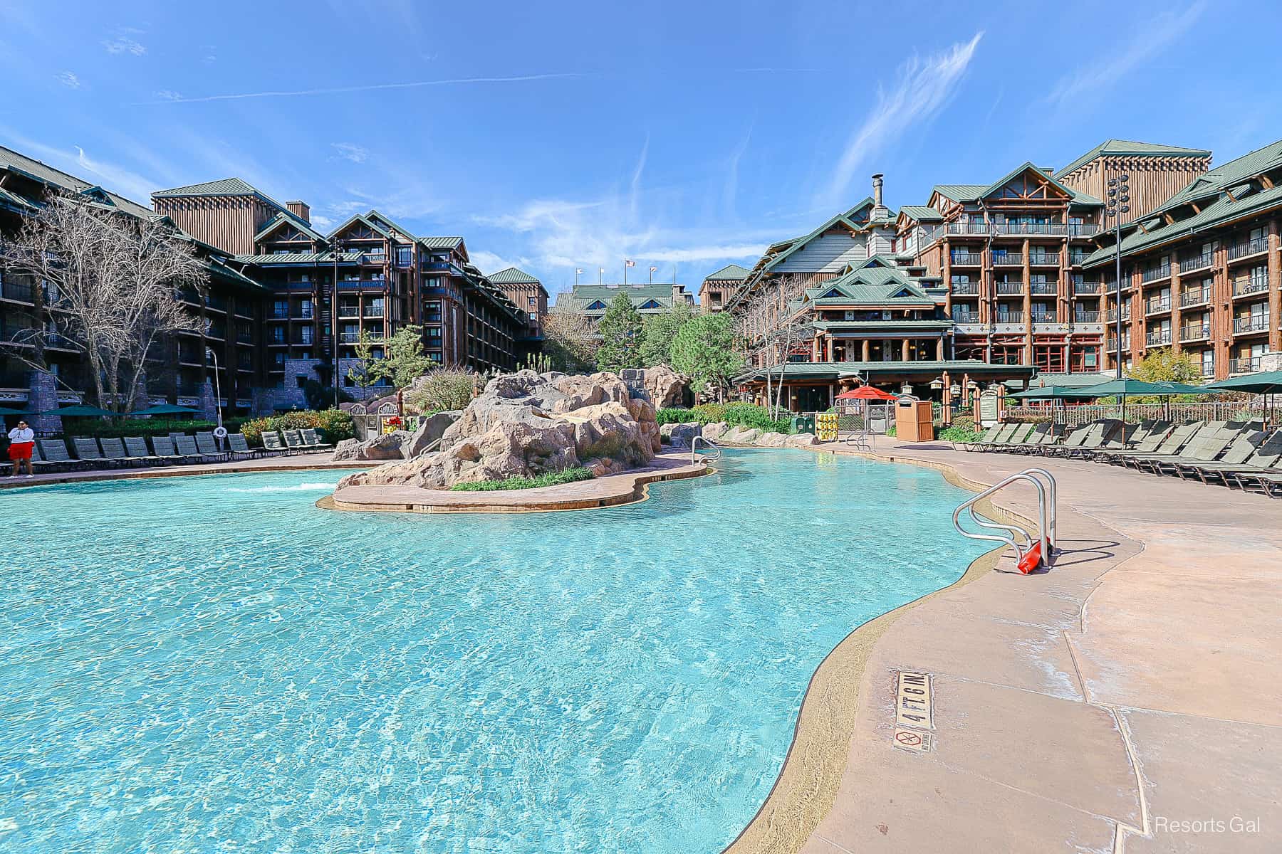 a pool with a rock formation in the center of it at Disney's Wilderness Lodge