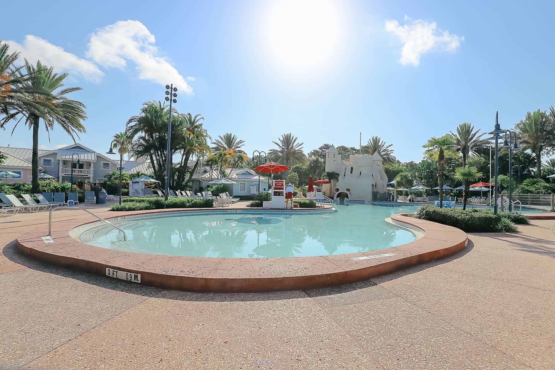 The edge of the feature pool at Disney's Old Key West with sun shining. 