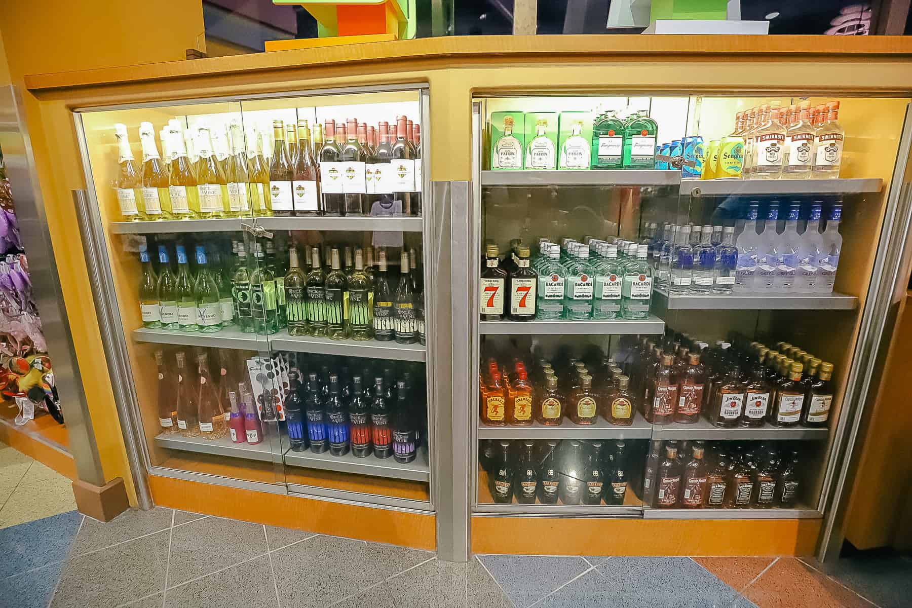 A locked cabinet of various liquors sits near the cash register. 