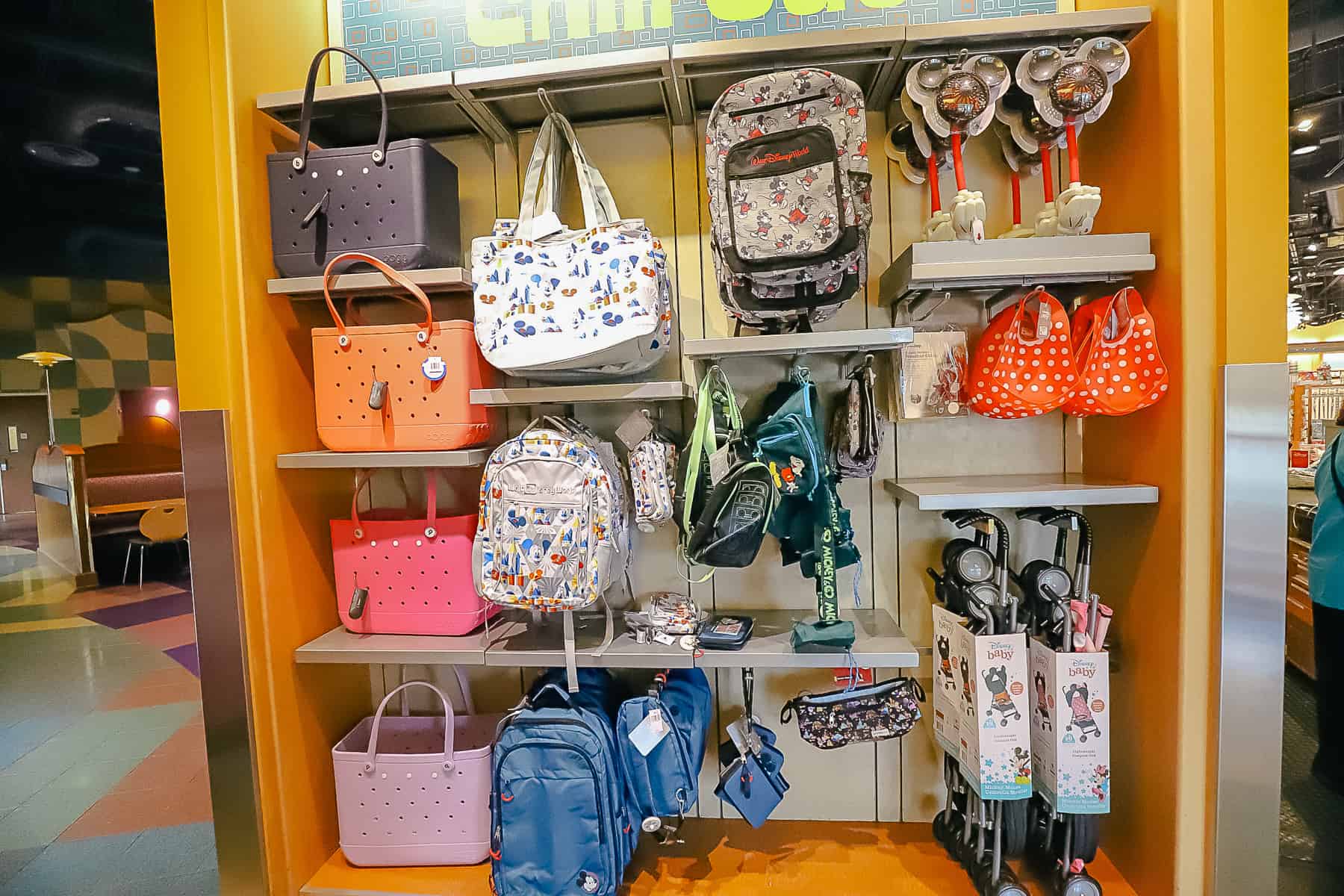 a display with bags, backpacks and umbrella strollers 