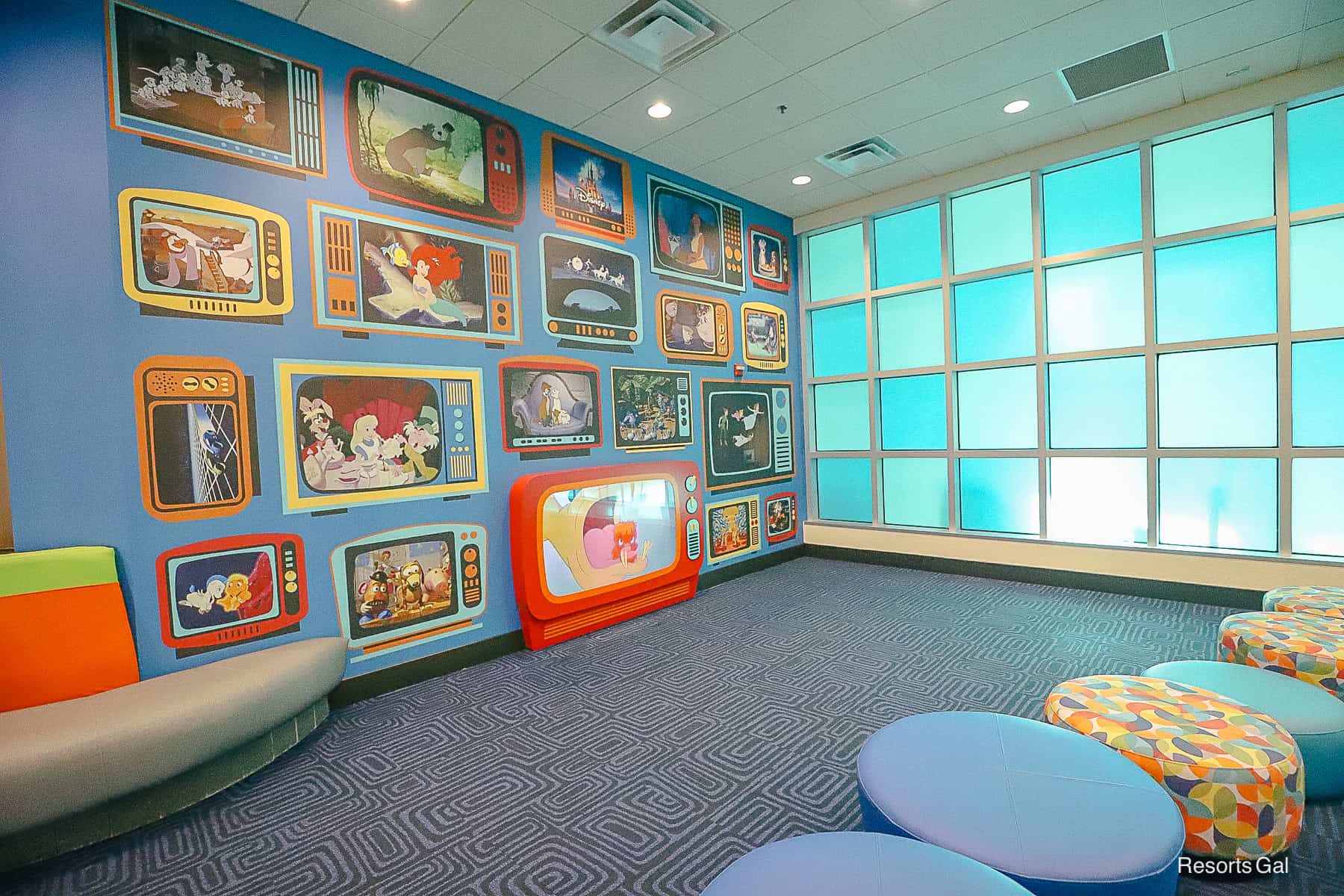 a children's area featuring stools or kids to watch television 