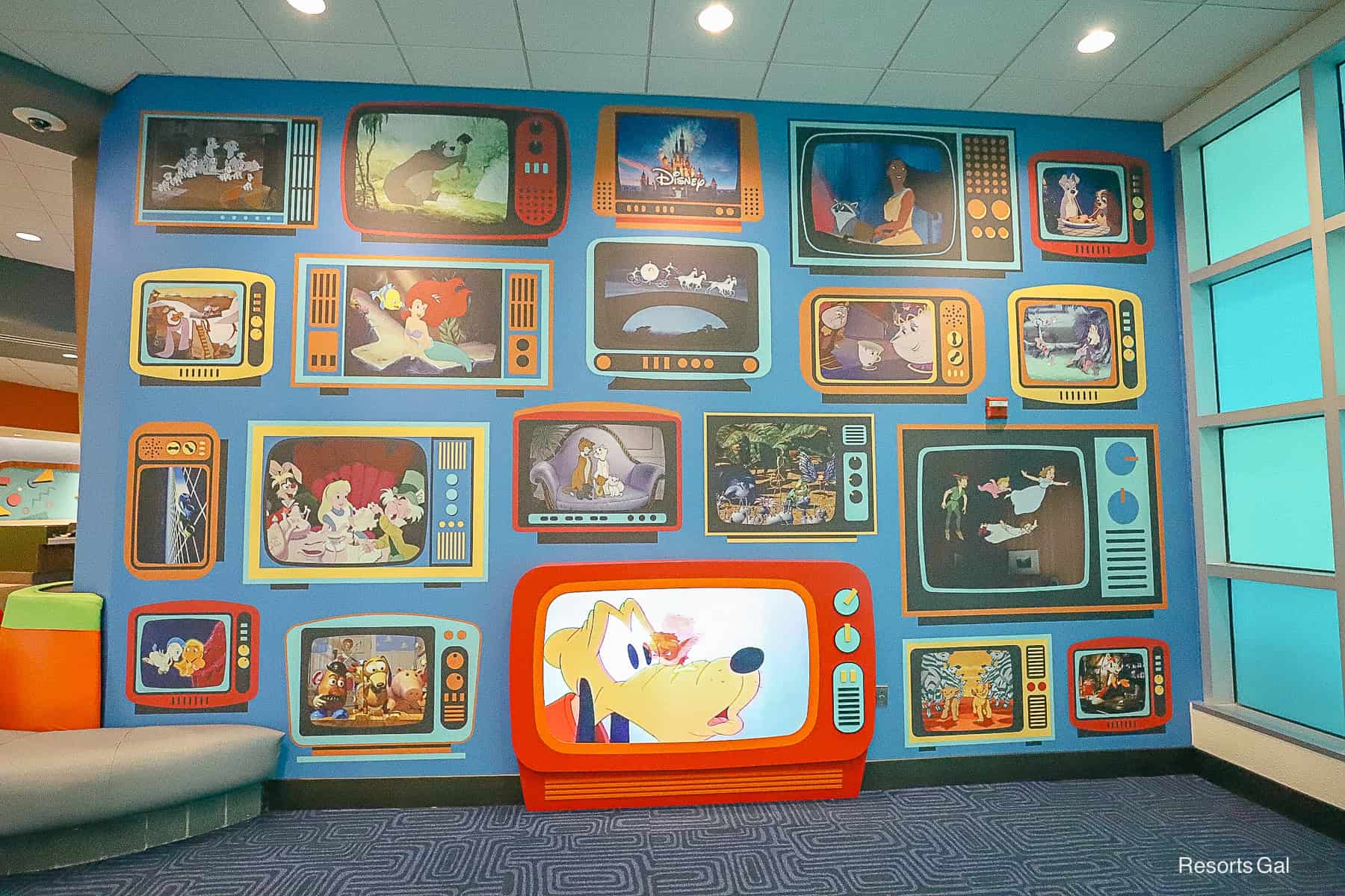 a blue feature wall with painted television scenes featuring classic Disney cartoons 