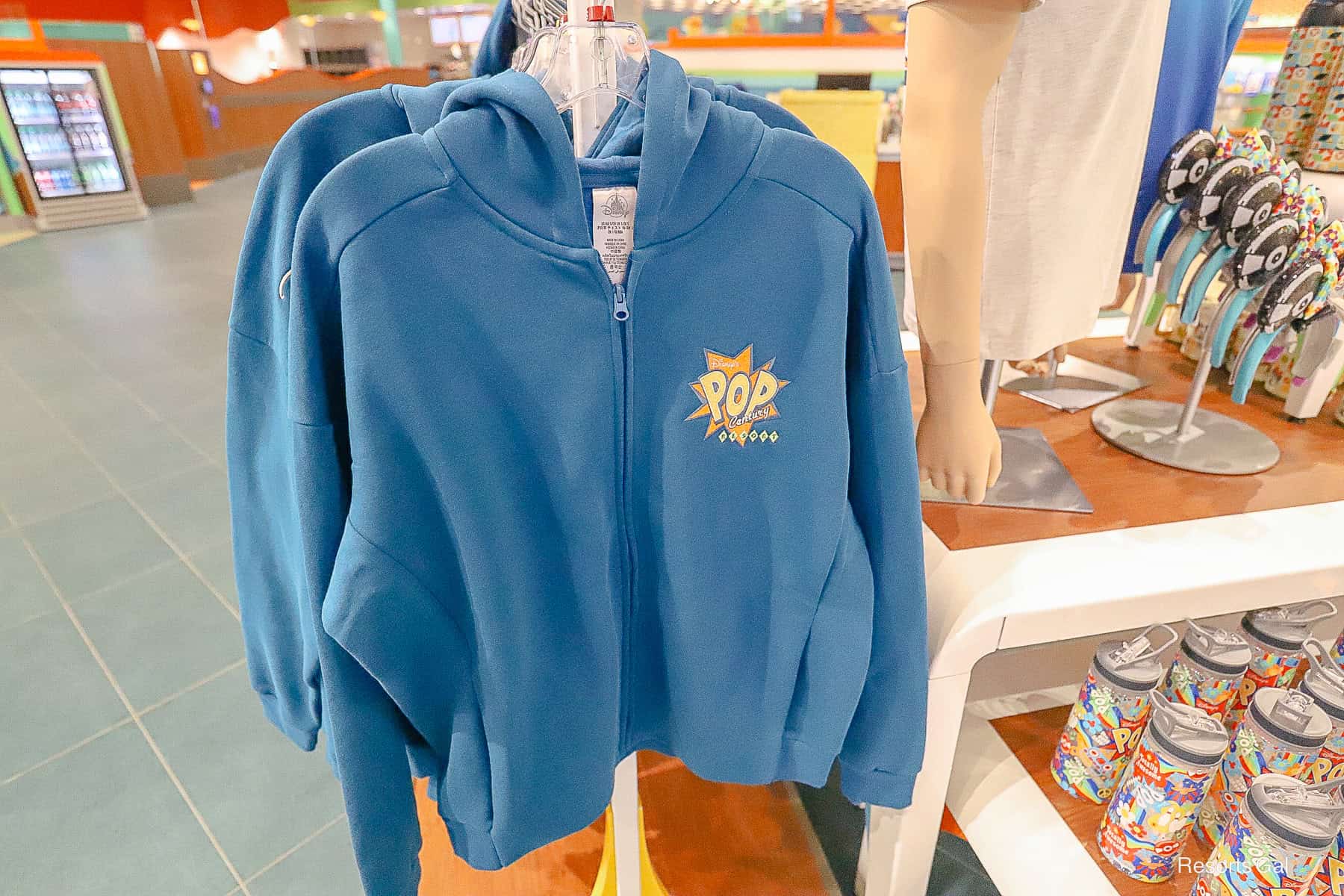 the front of the turquoise zip up Pop Century Resort jacket