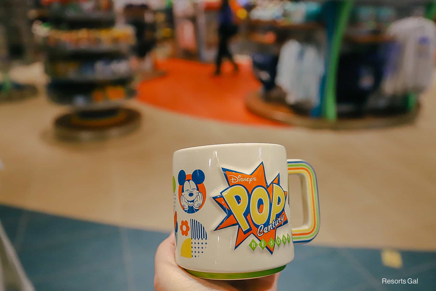 the Pop Century Resort logo printed on the mug in yellow and orange with blue and green outlines