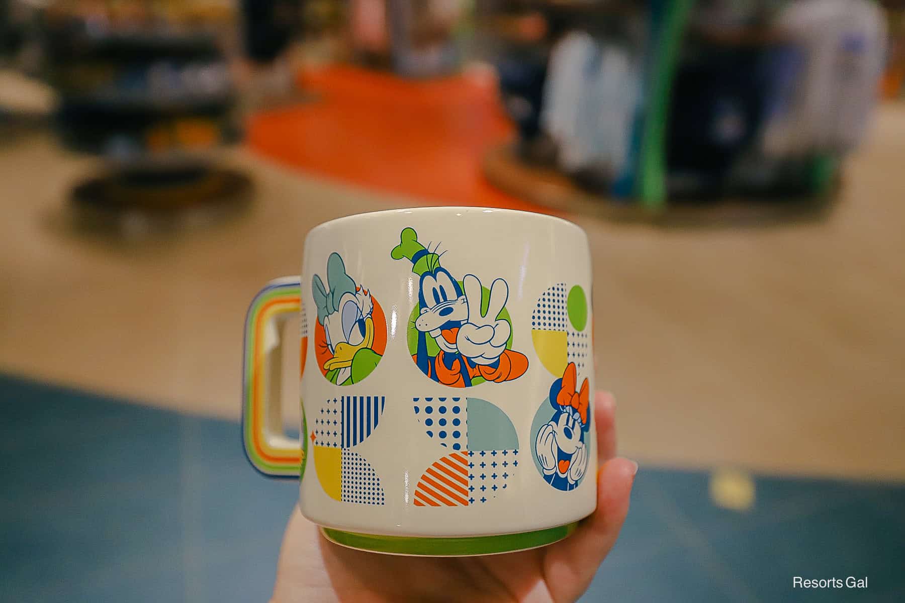 Characters on the Pop Century mug include Donald Duck, Daisy Duck, Goofy, Minnie Mouse, and Mickey Mouse