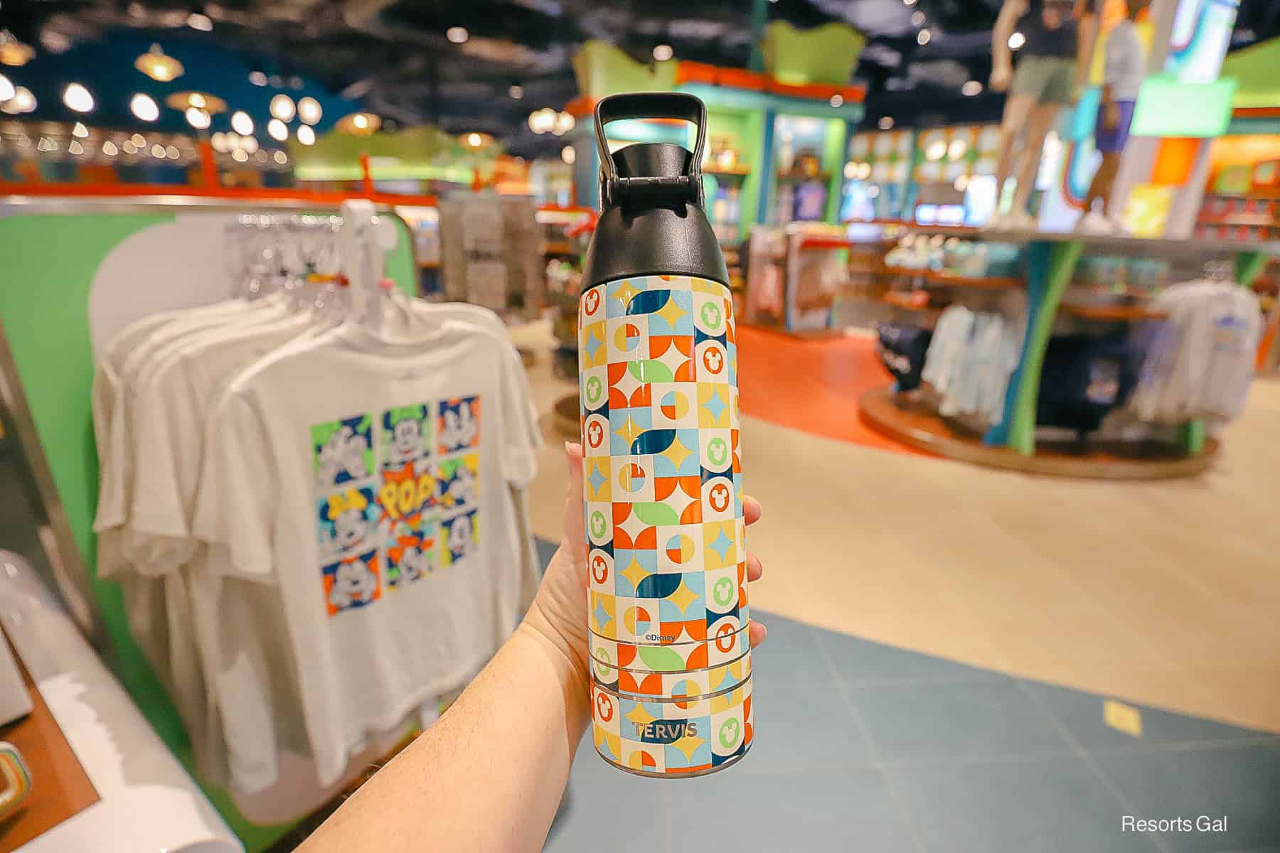 the back print of the Pop Century tumbler features blue, yellow, orange and cream colors