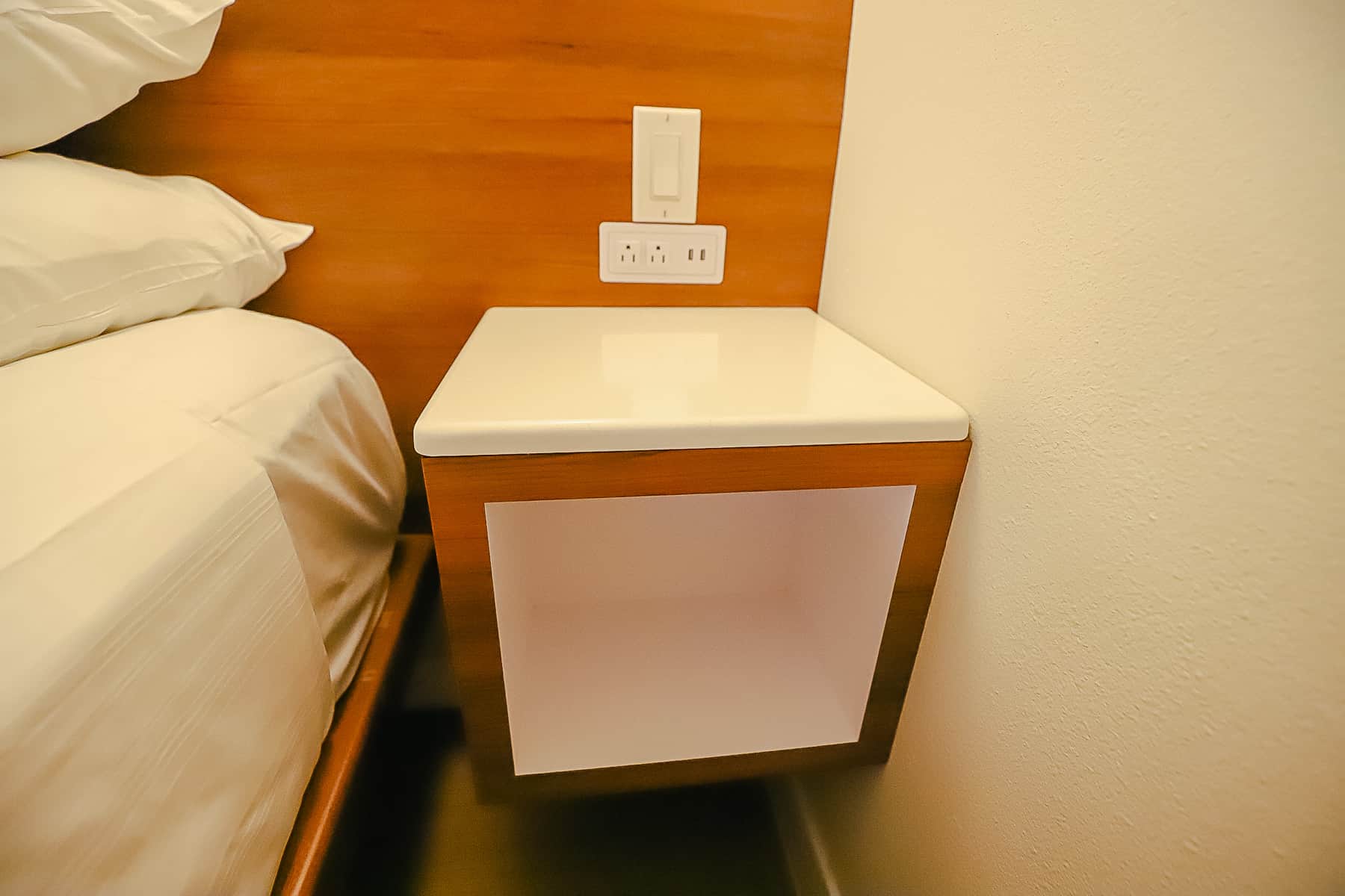 a built-in nightstand with outlets and USB ports