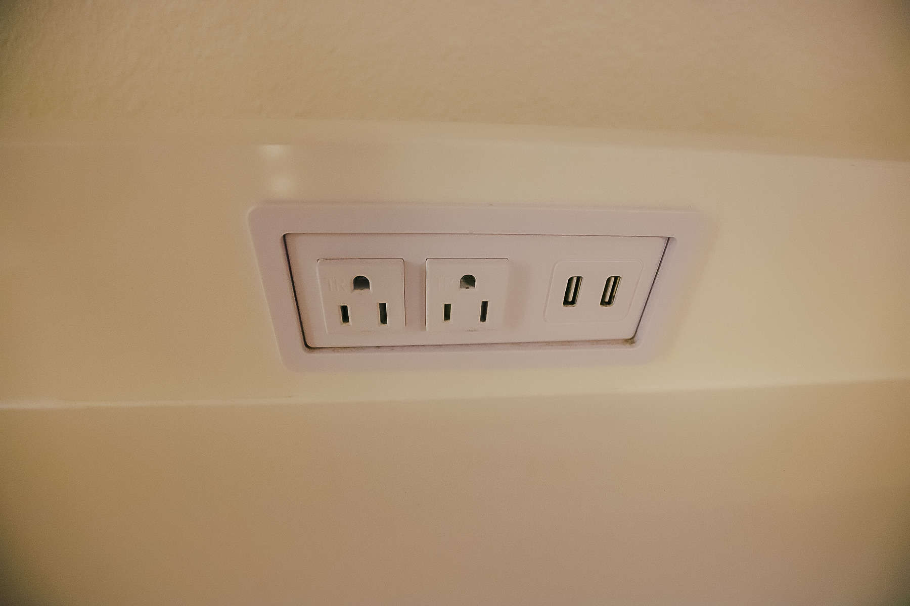 one of two sets of outlets and USB ports built in over the dresser 