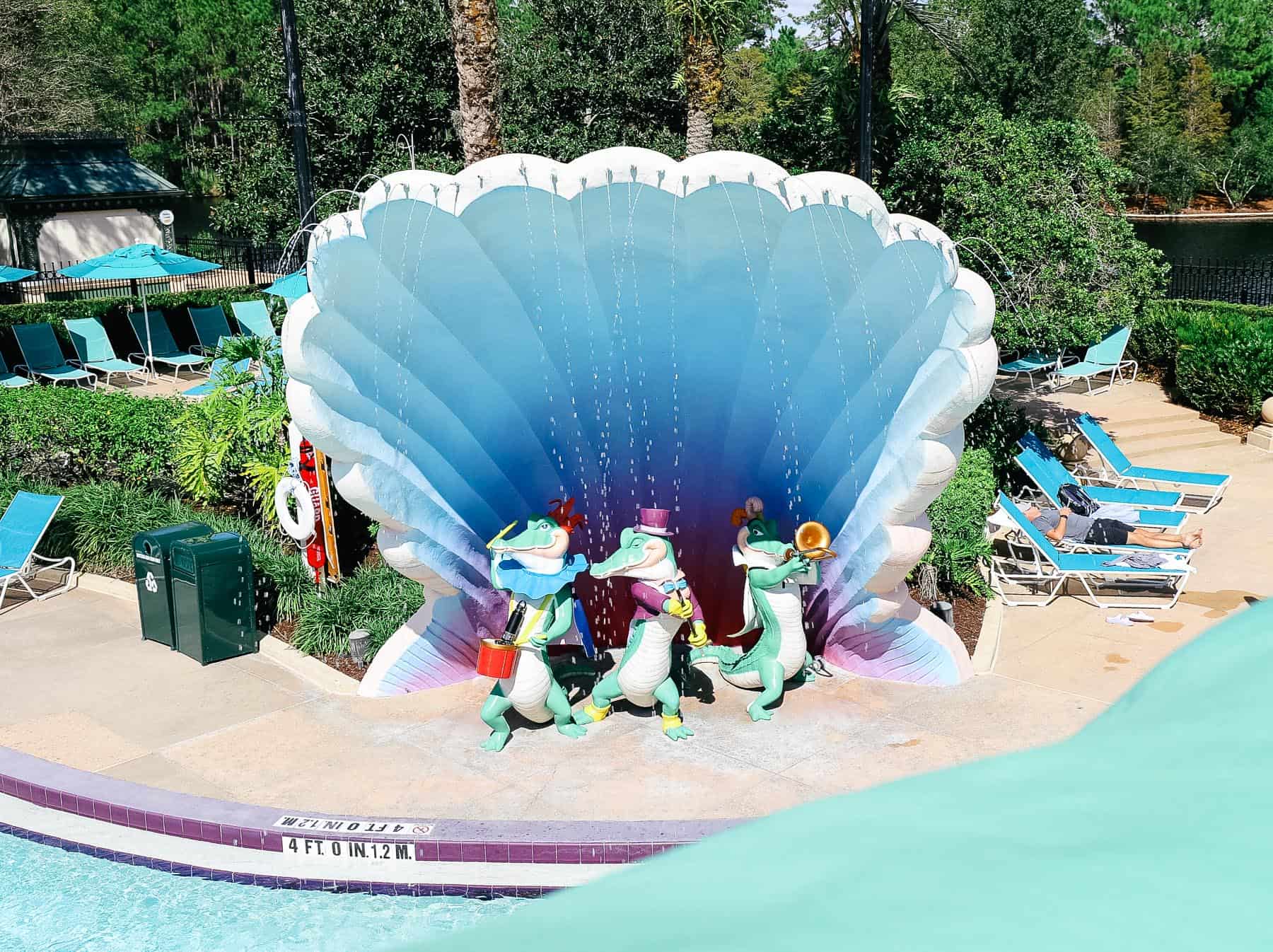 a view of several alligators under a water feature at the Port Orleans French Quarter pool 