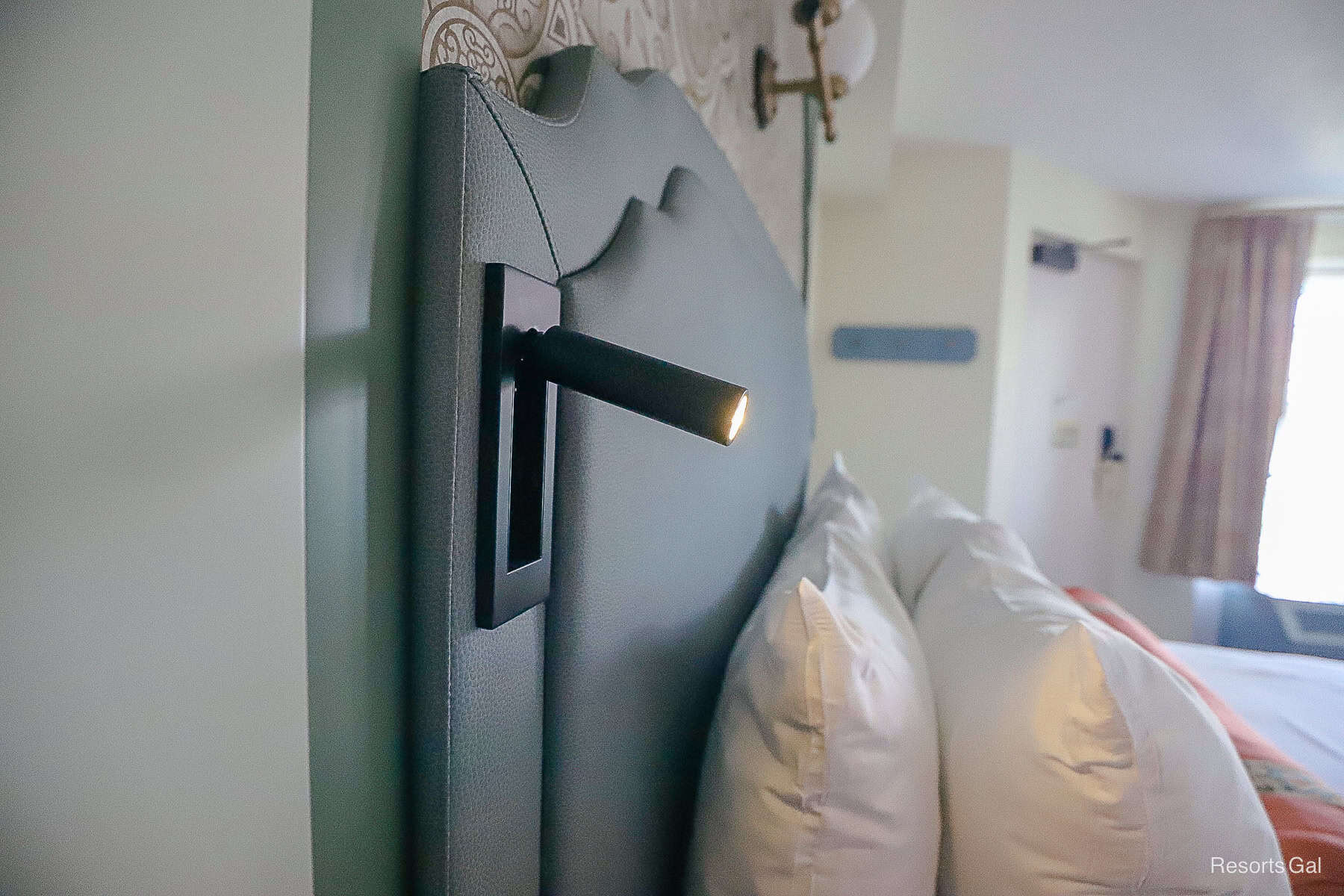 a nightlight that extends from the bed's headboard