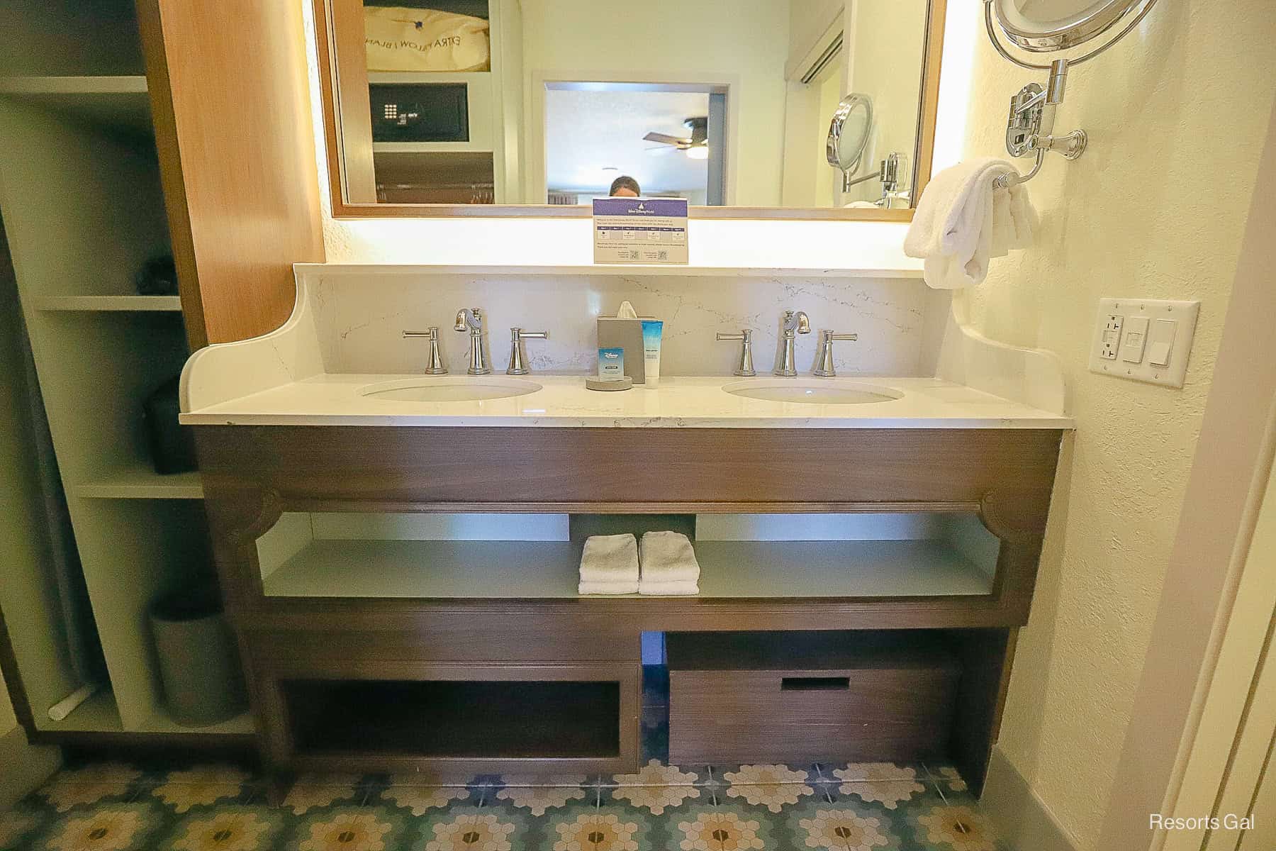 the vanity area with a shelf in the middle and a step stool