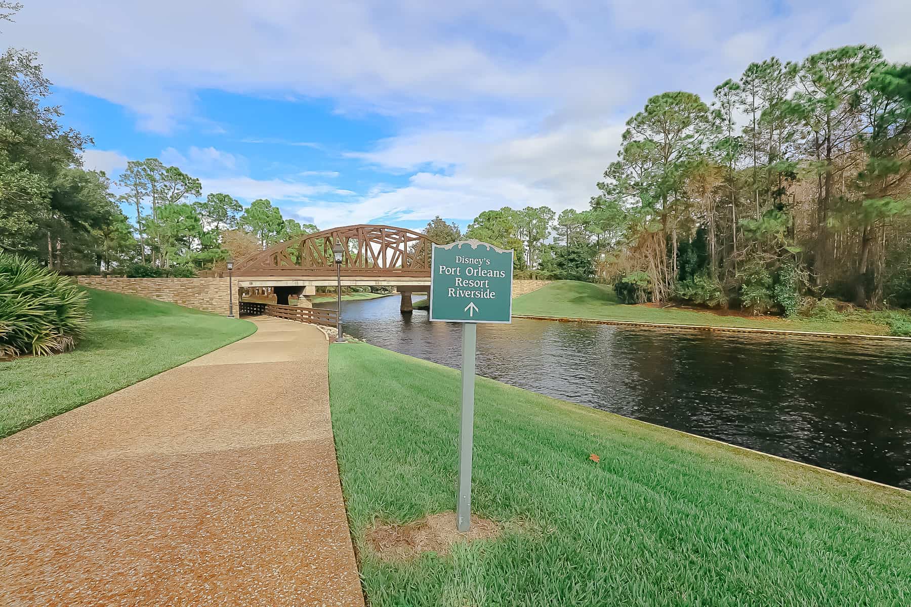 a sidewalk next to the river between Port Orleans French Quarter and Riverside 