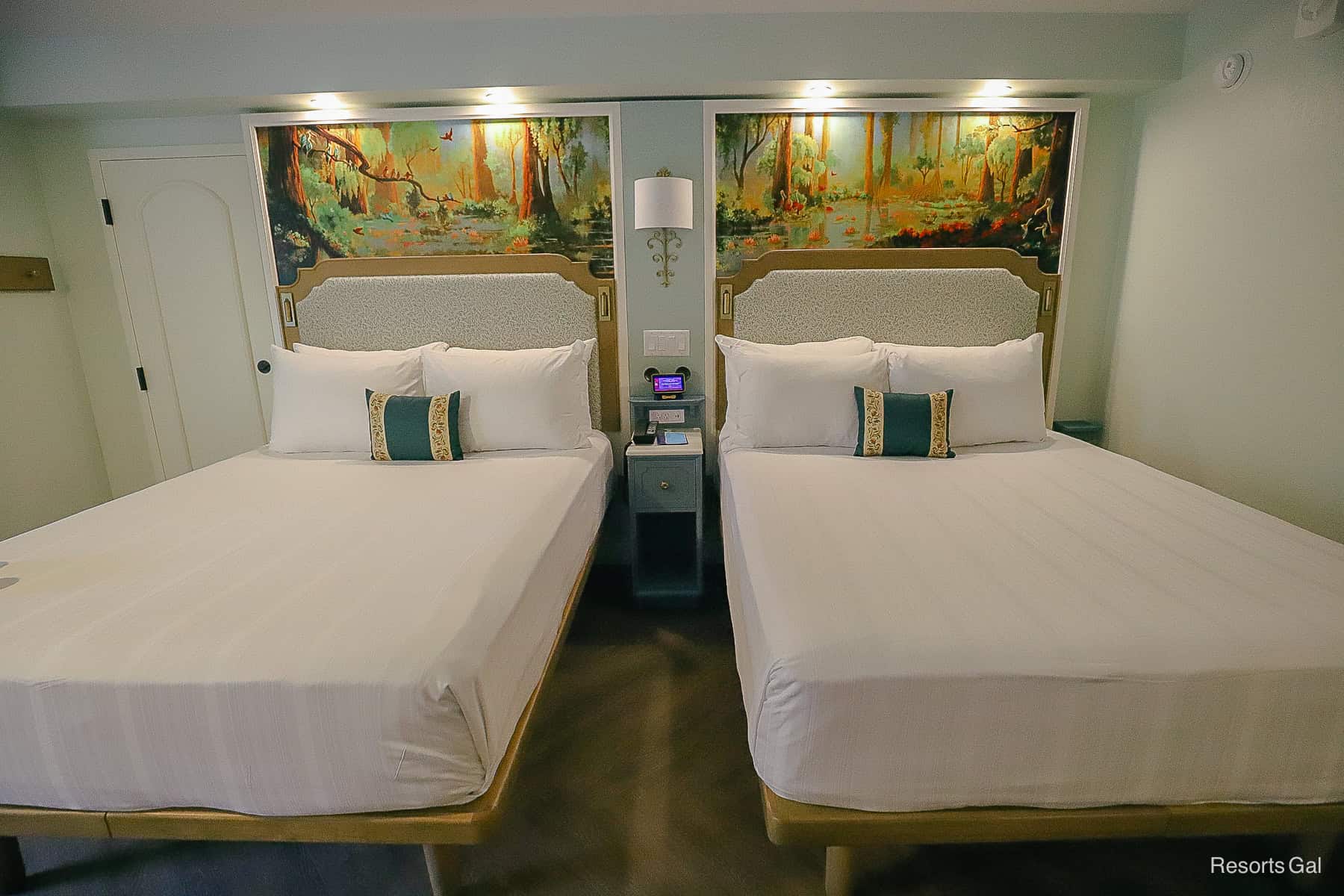 two queen beds with artwork above the headboards