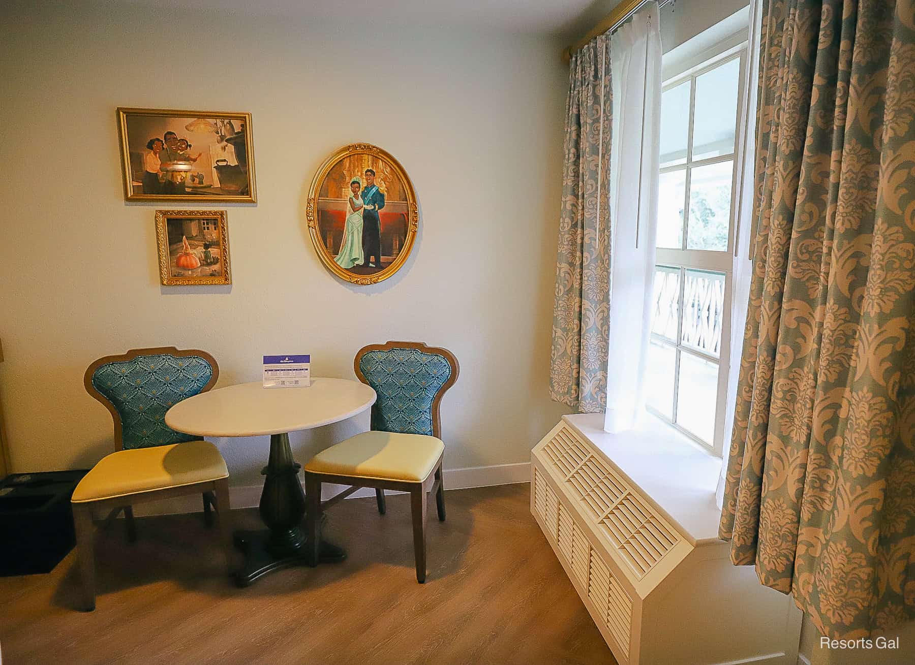 front corner of the room with window, table and two chairs, and HVAC unit