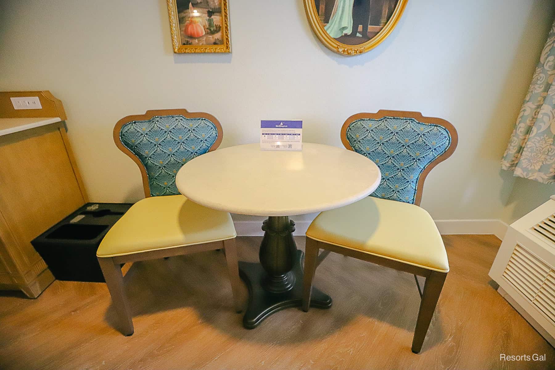 two chairs with a marble table