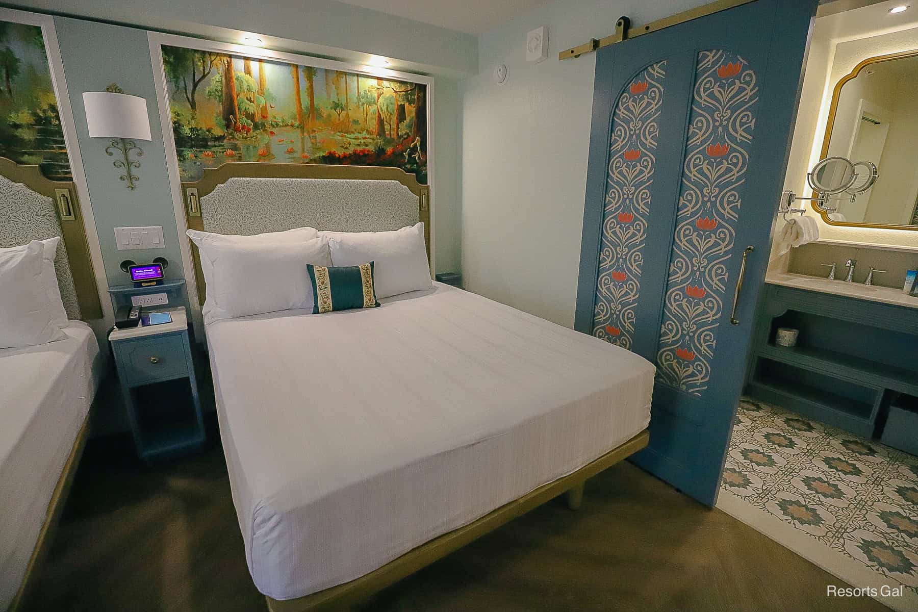 an angle of the room that shows how the panel door separates the bed area from the bath