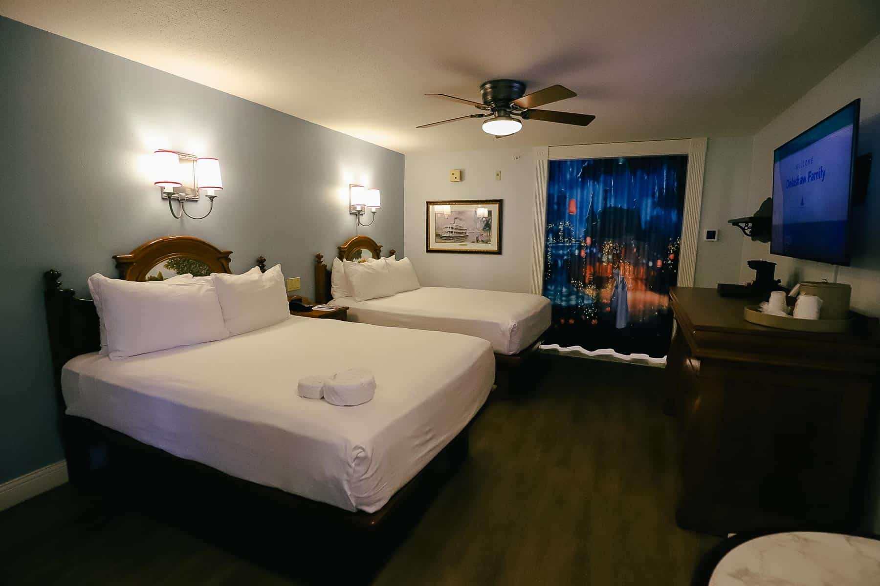 a standard guest room with two queen beds in a moderate resort 