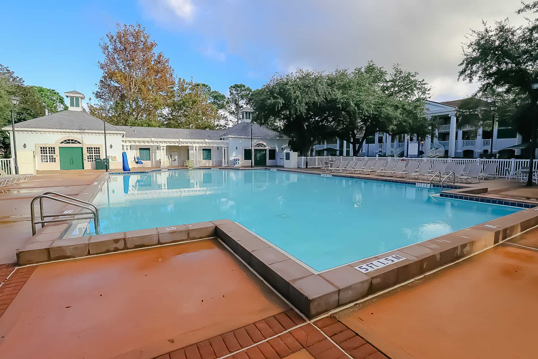 a white building sitting behind the pristine pool at Port Orleans Riverside 