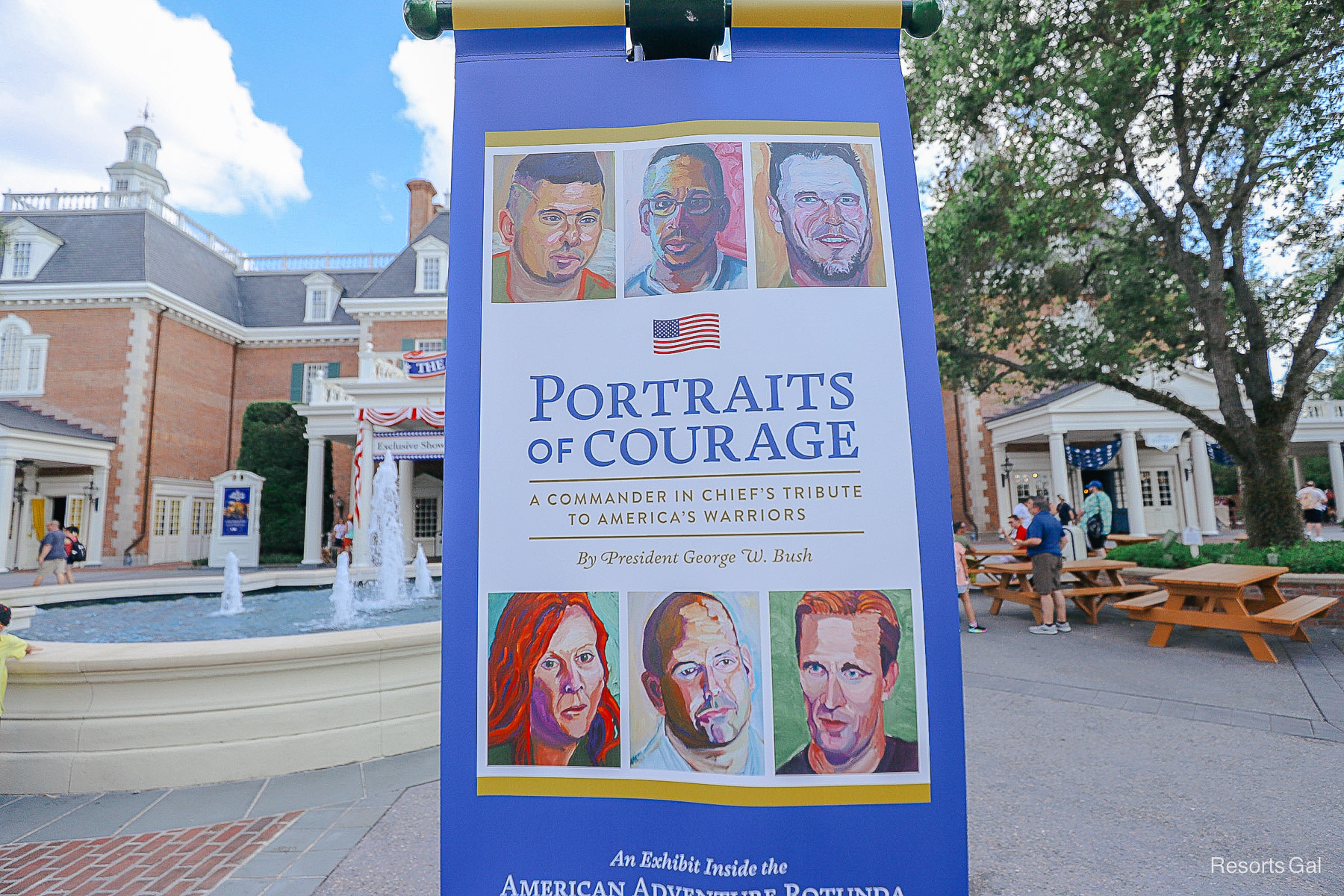 a sign advertising the Portraits of Courage exhibit at Epcot 