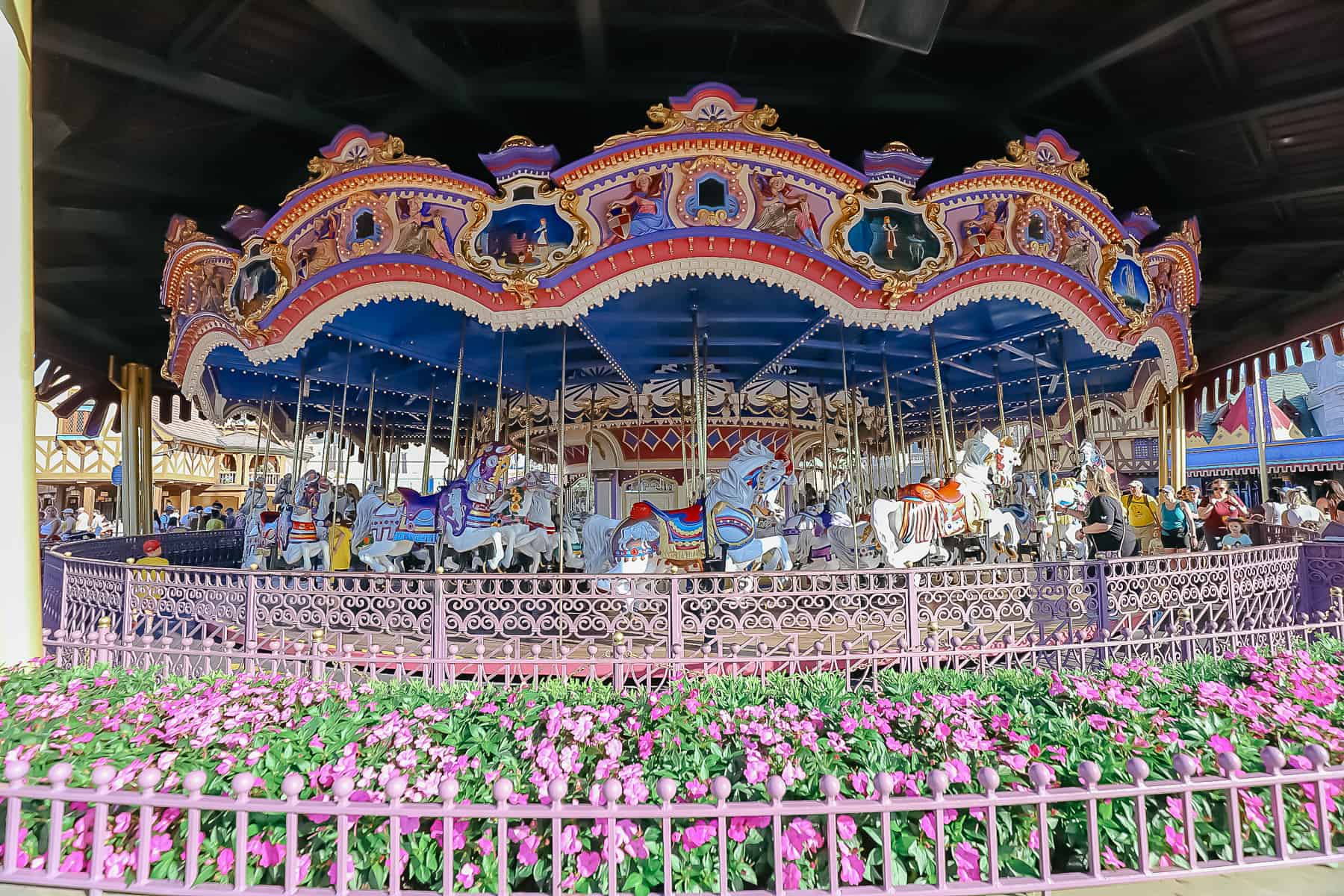 details look at the painted railings and flowers that surround Prince Charming Carrousel at Magic Kingdom