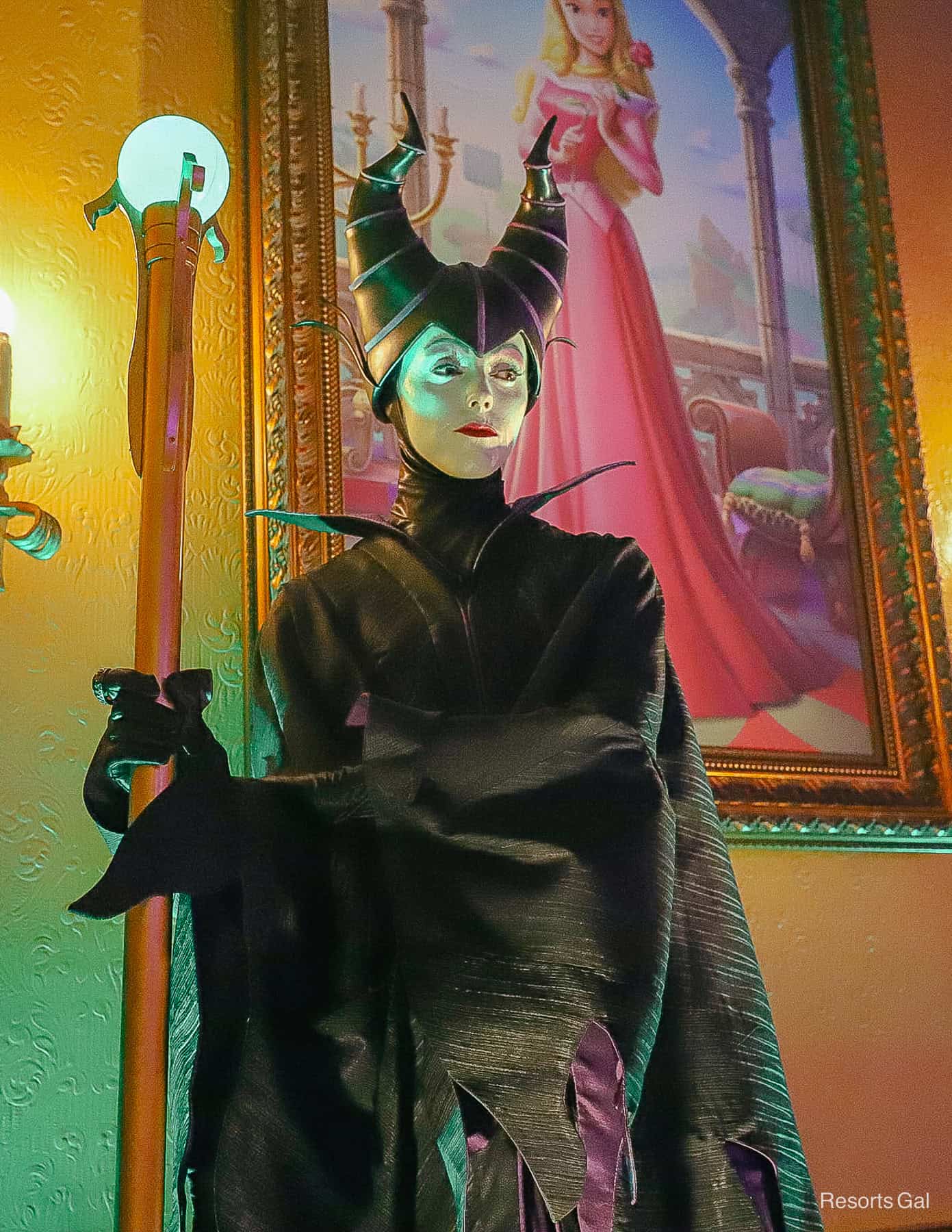 maleficent in complete costume with green skin and staff