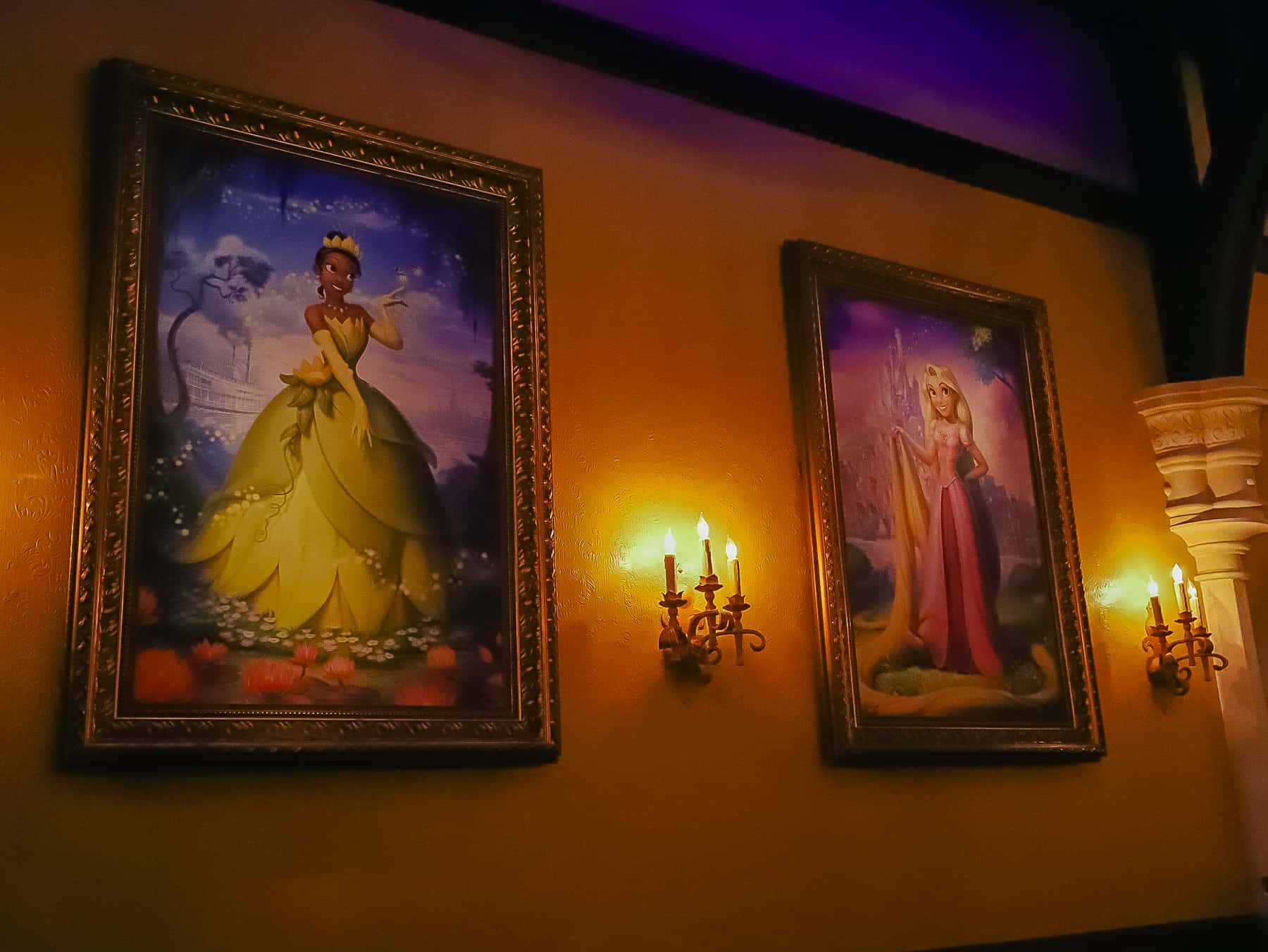 Portraits of Tiana and Rapunzel hang inside Princess Fairytale Hall 