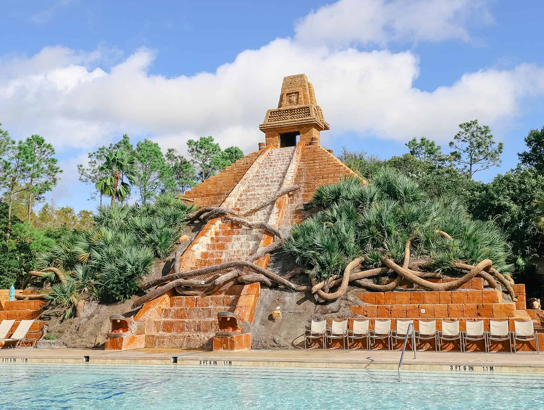 A faux Mayan pyramid sits at the back of the pool.
