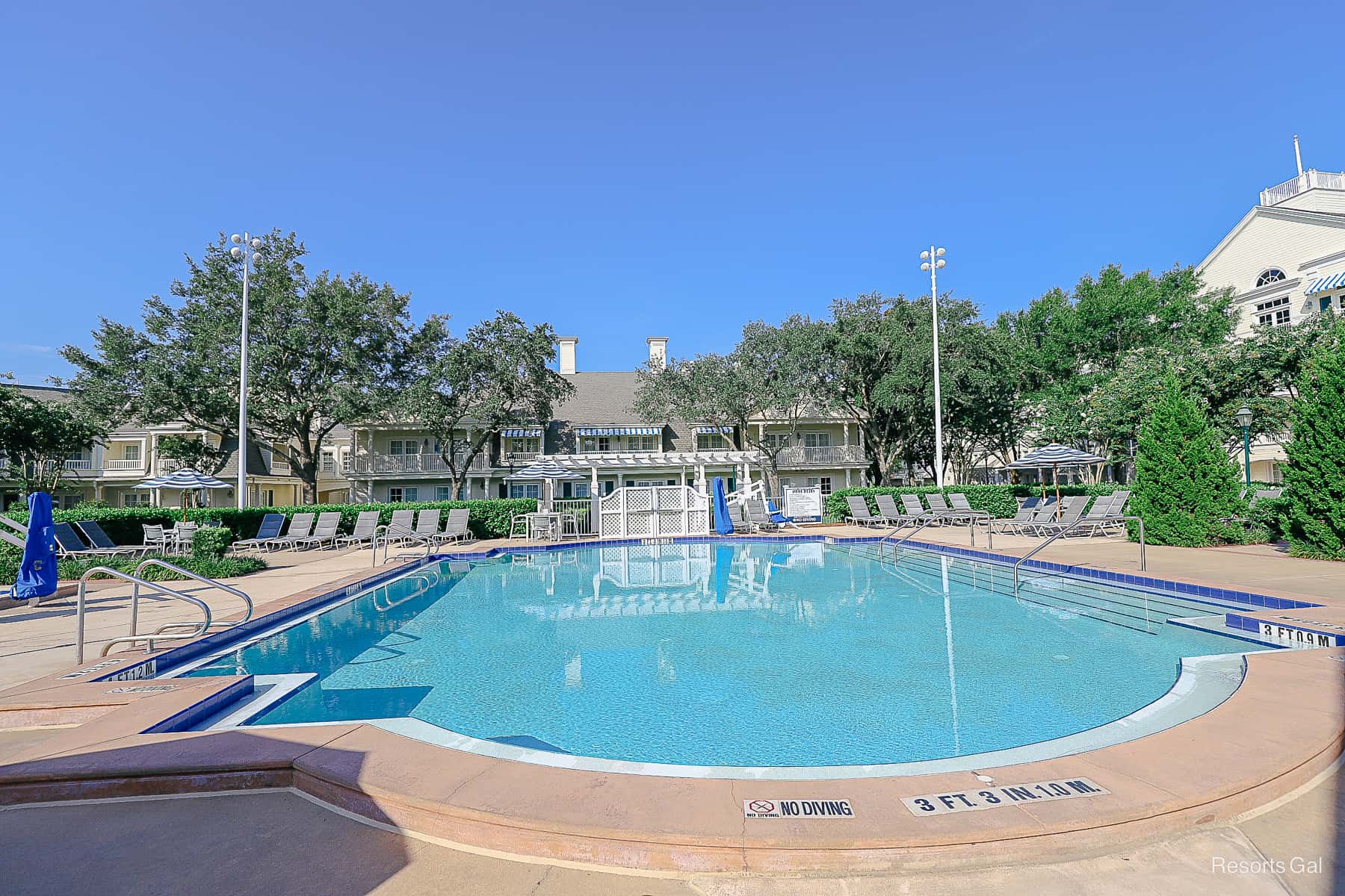 a pool with a rectangular shape with clear blue waters 