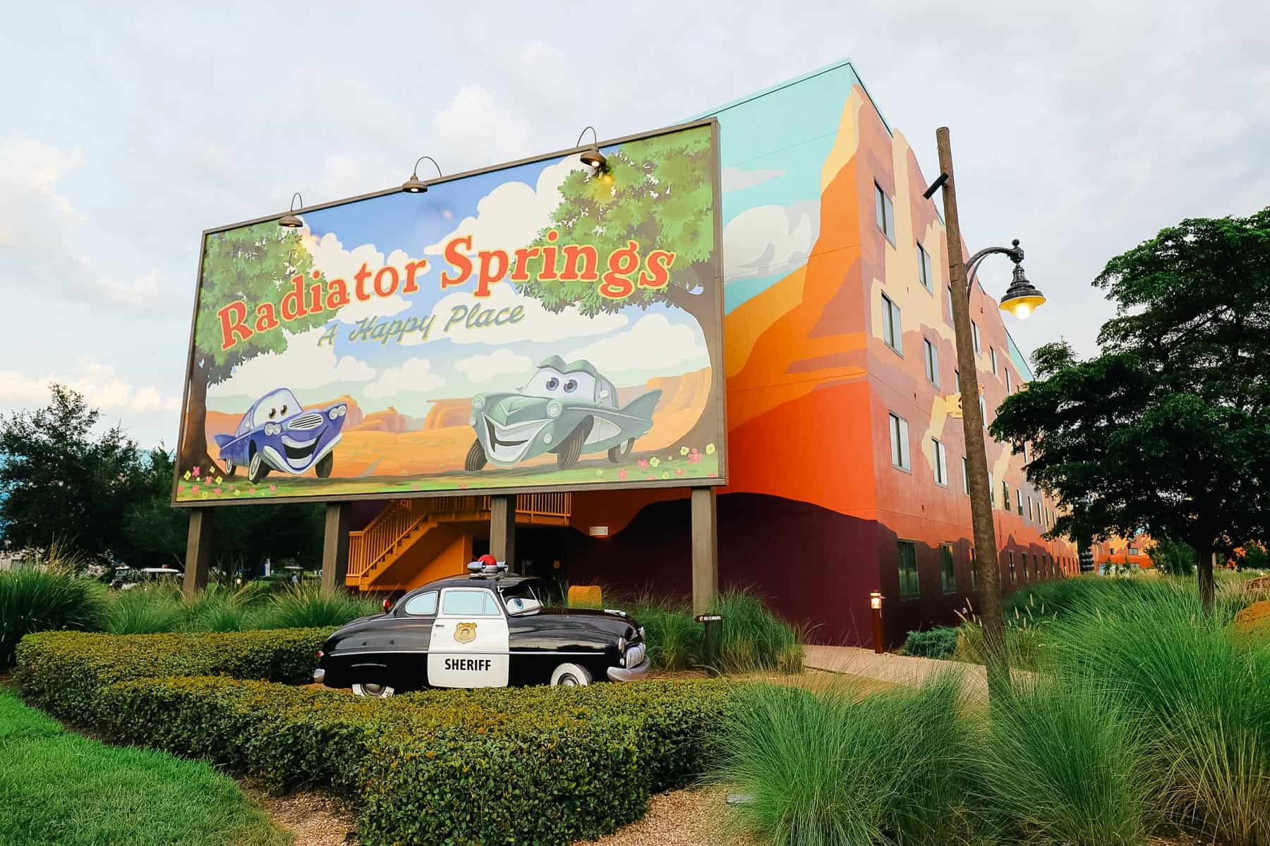 Radiator Springs billboard with Sheriff from Cars sitting out front 