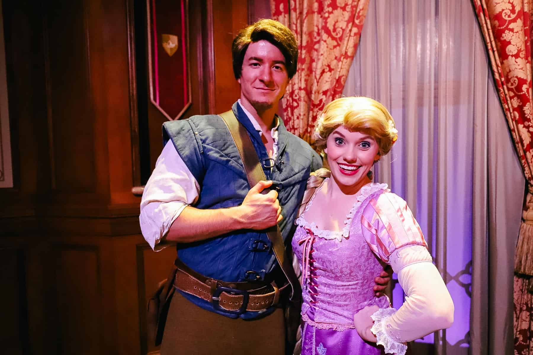 Flynn Rider and Rapunzel pose together at Magic Kingdom. 